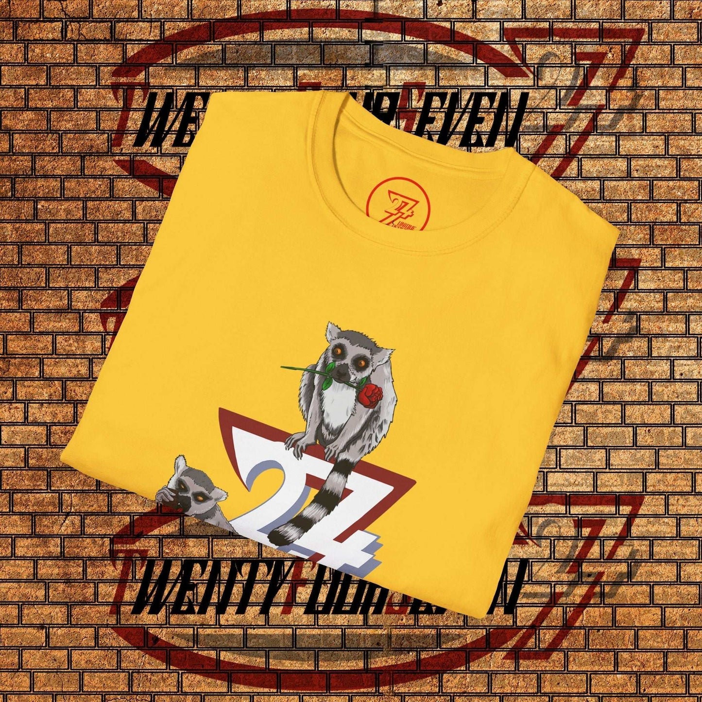 Neatly folded yellow Lemur L’Amour tee showing the artistic animal illustration, perfect for a romantic gift.