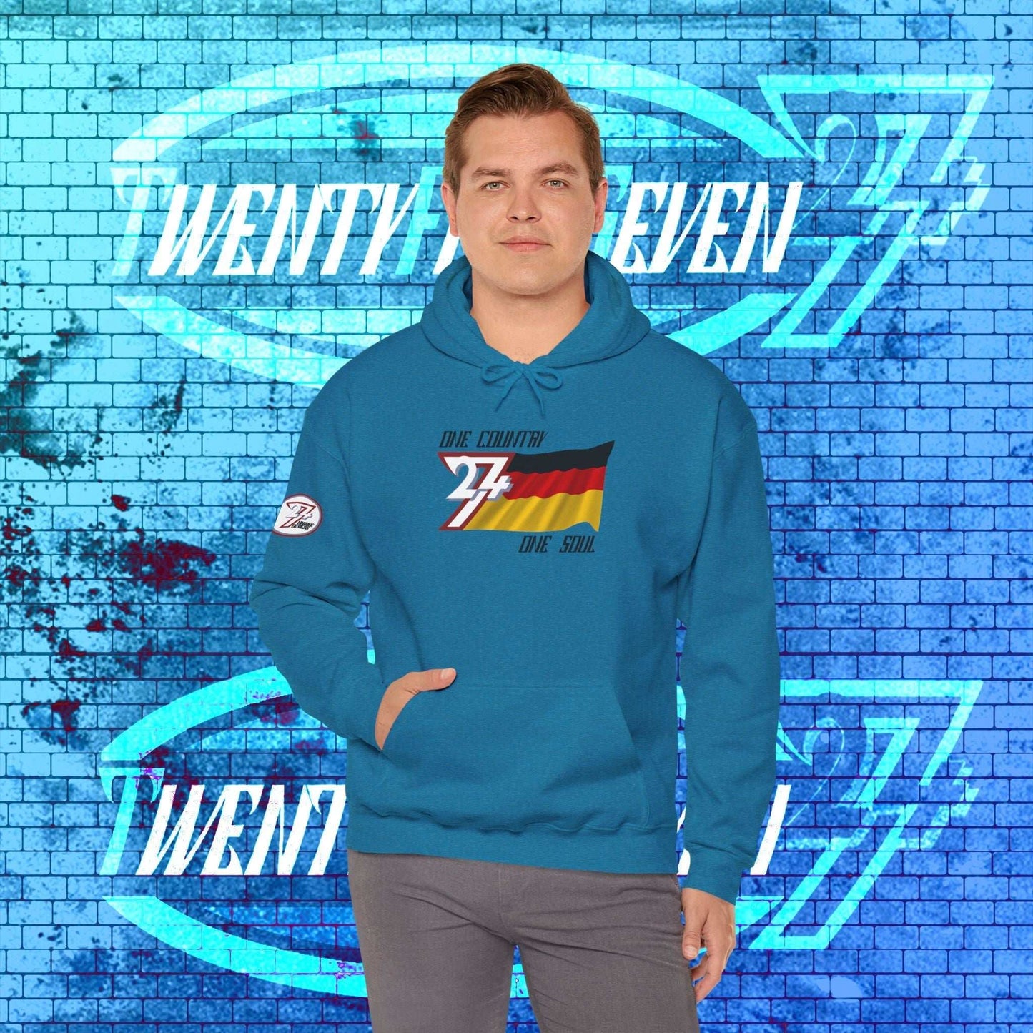 Model wearing the Deutschland "Axis" hoodie in Ocean Blue, styled for a modern, high-tier urban look.