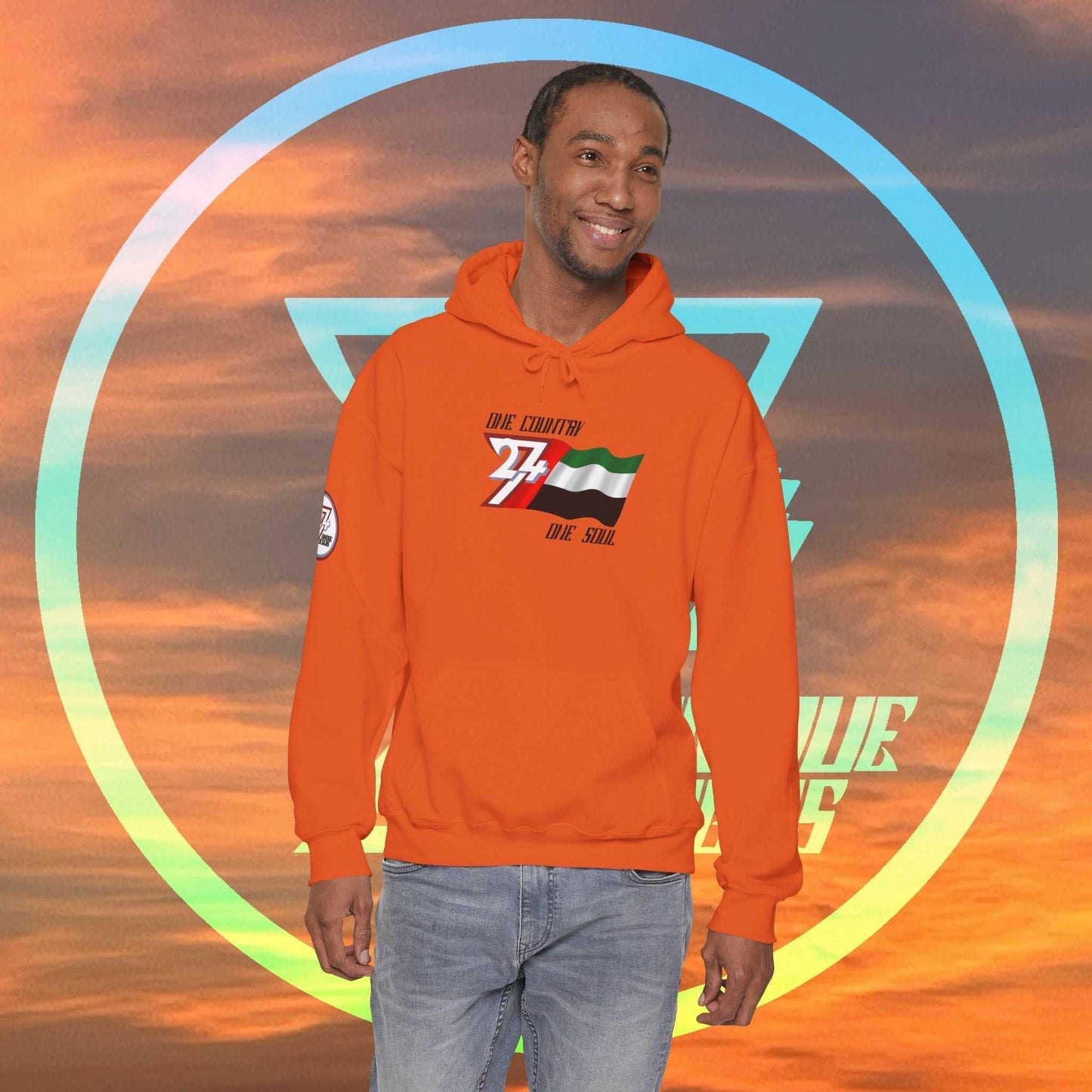 Male model wearing the UAE "Vision" edition hoodie in Orange, showing a modern, refined streetwear look.