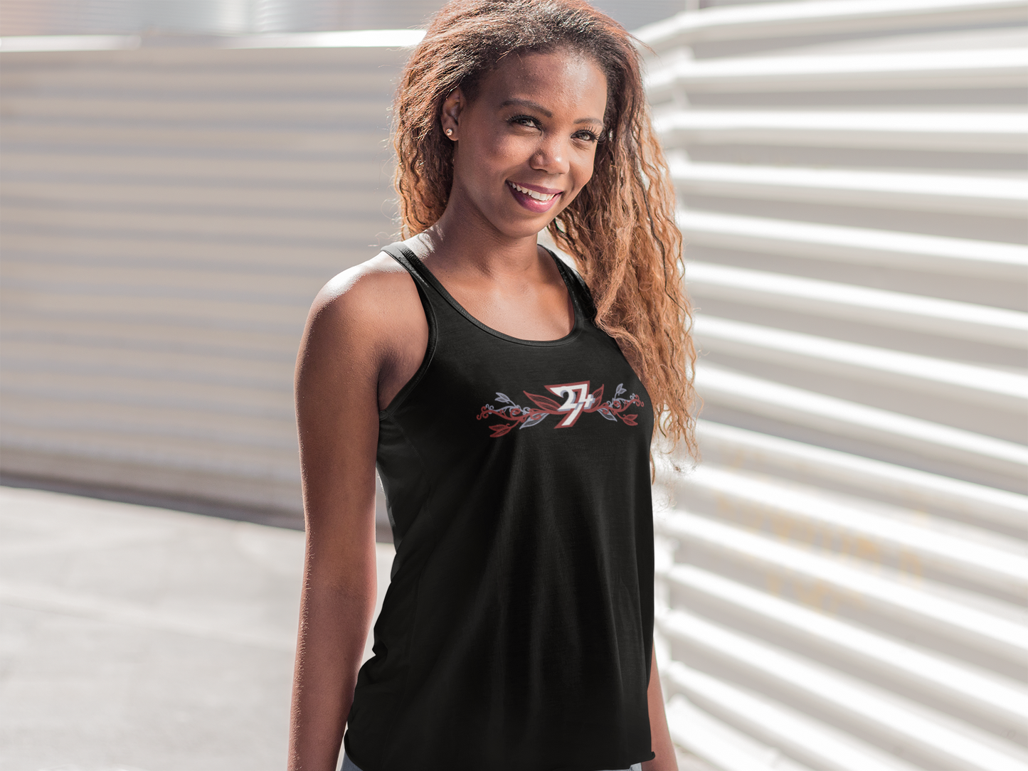 Woman wearing the black floral graphic tank top with a logo