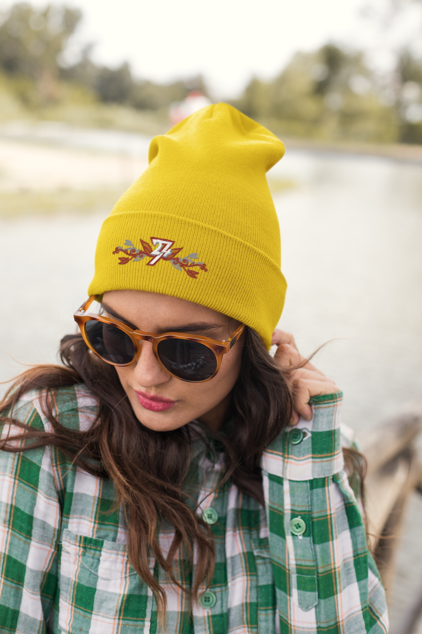 Front view of a female model wearing the gold 24/7 Unique Designs floral winter hat.
