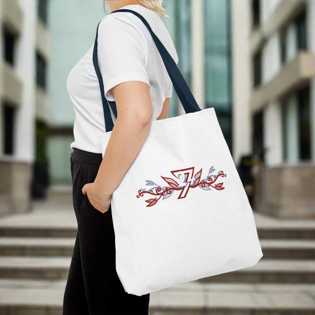 Extra large tote bag with unique floral pattern and blacj handle on woman's shoulder