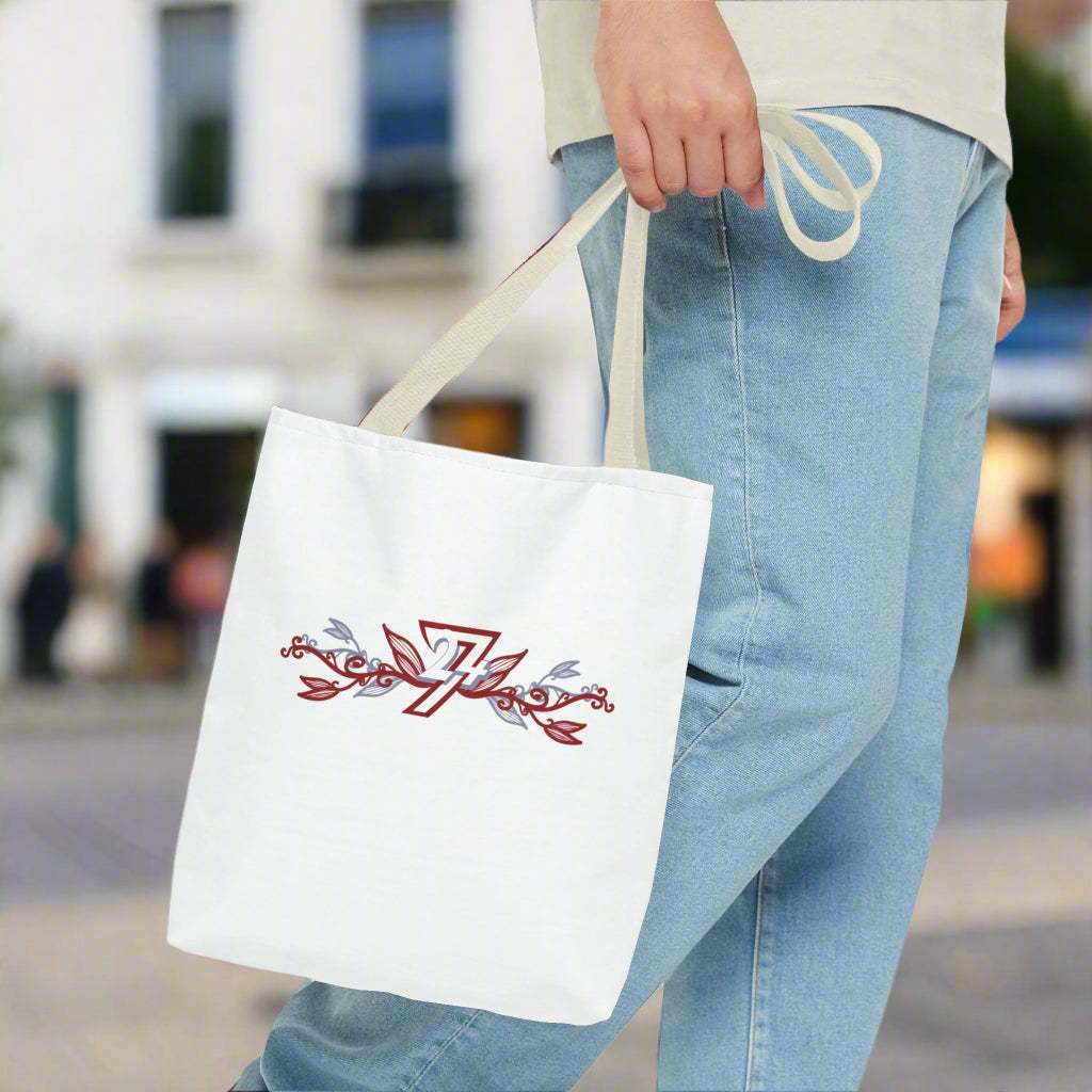 Floral tote bag with unique design with beige handle in man's hand on street