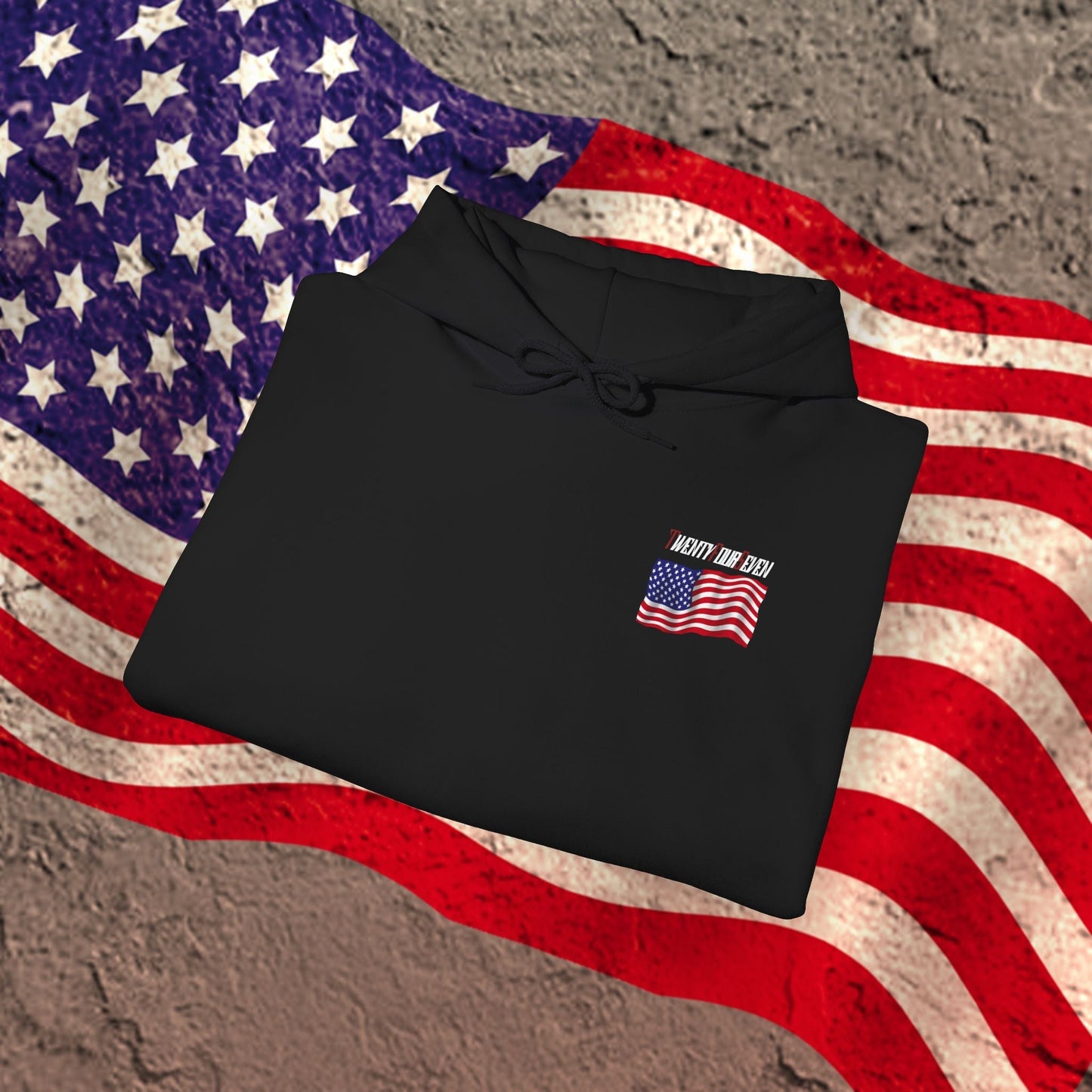 Folded black US flag hoodie with printed American flag and "Honor Our DAD" text on a textured American flag background