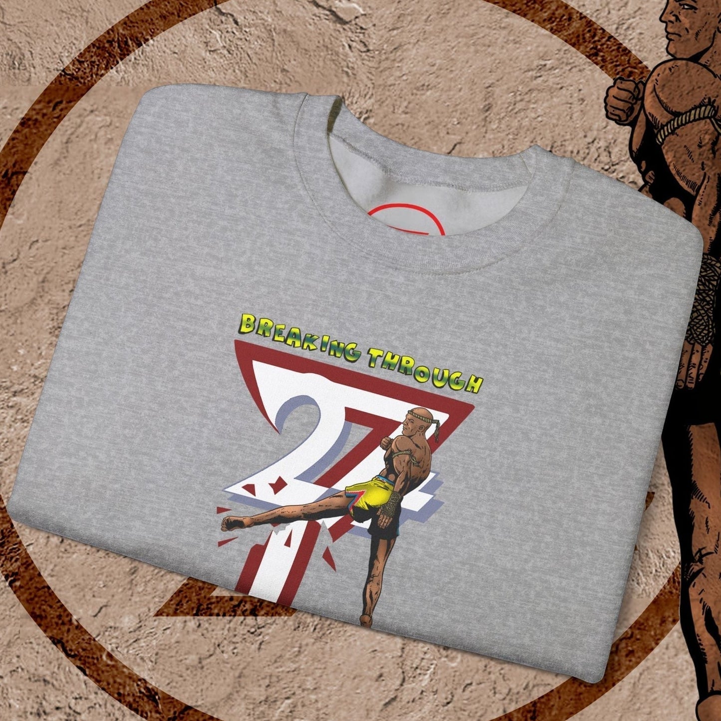 Gray Muay Thai sweatshirt with vibrant hand-drawn fighter design and "Breaking Through" text, made from cotton-polyester blend.