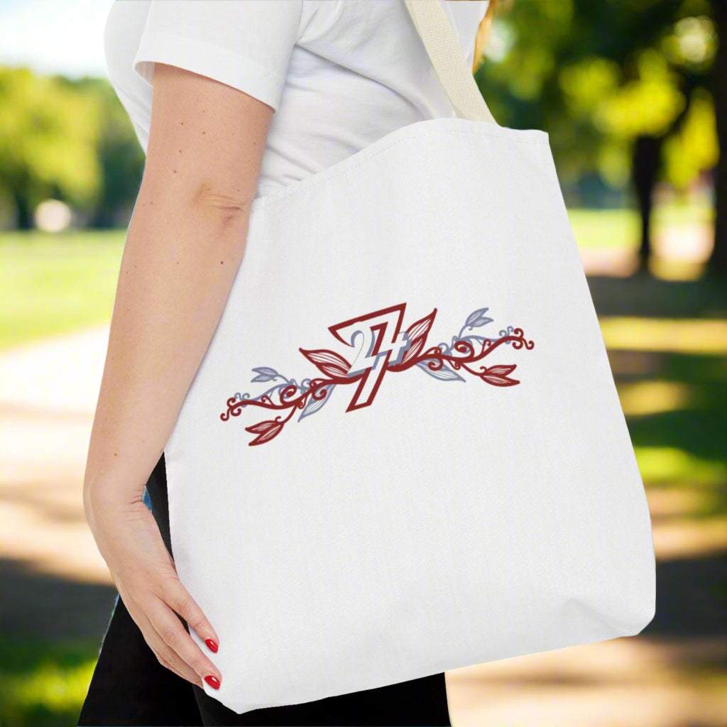 Larges tylish floral tote bag with beige handle resting on  woman's shoulder