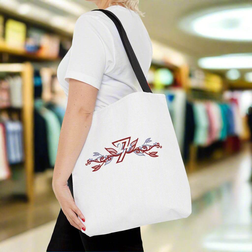 White stylish floral design tote bag on woman's shoulder