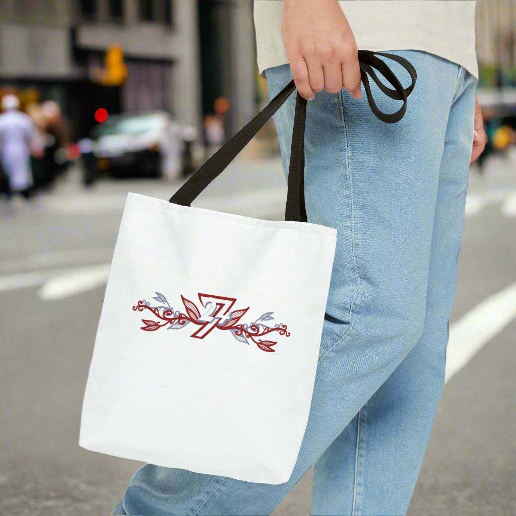 man carries the White tote bag with floral design