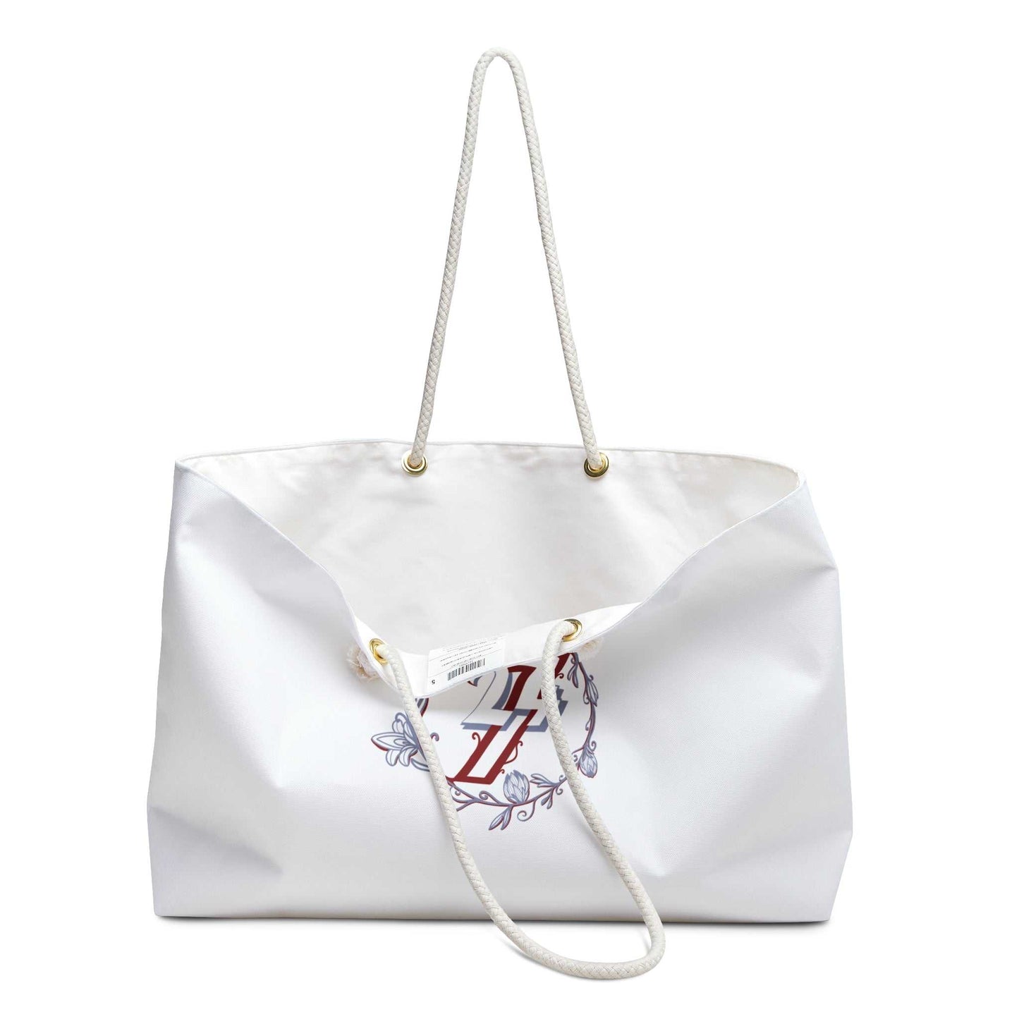 Slightly open view of the aesthetic overnight bag, showing the crisp white exterior, gold grommets, and the thick 27-inch rope handles.