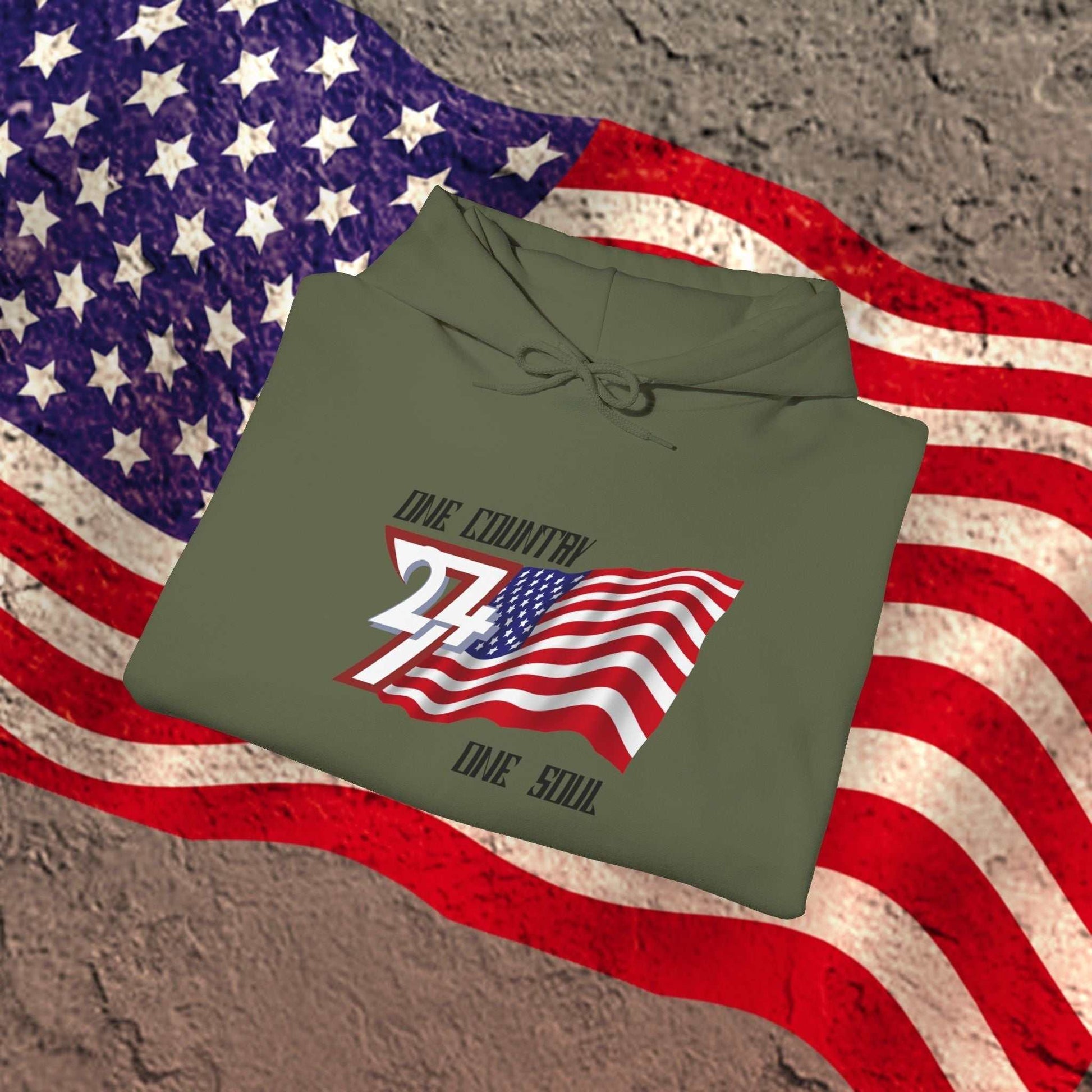A professional display of the USA flag hoodie in Army Green, folded to showcase the refined hand-drawn graphic and 8oz fabric weight.