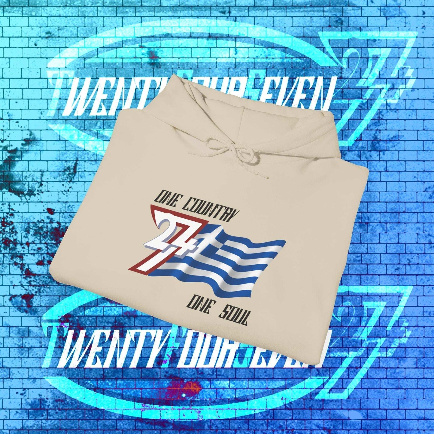 A stack-ready Beige Hellas hoodie, folded to display the refined digital flag sketch and premium thickness.