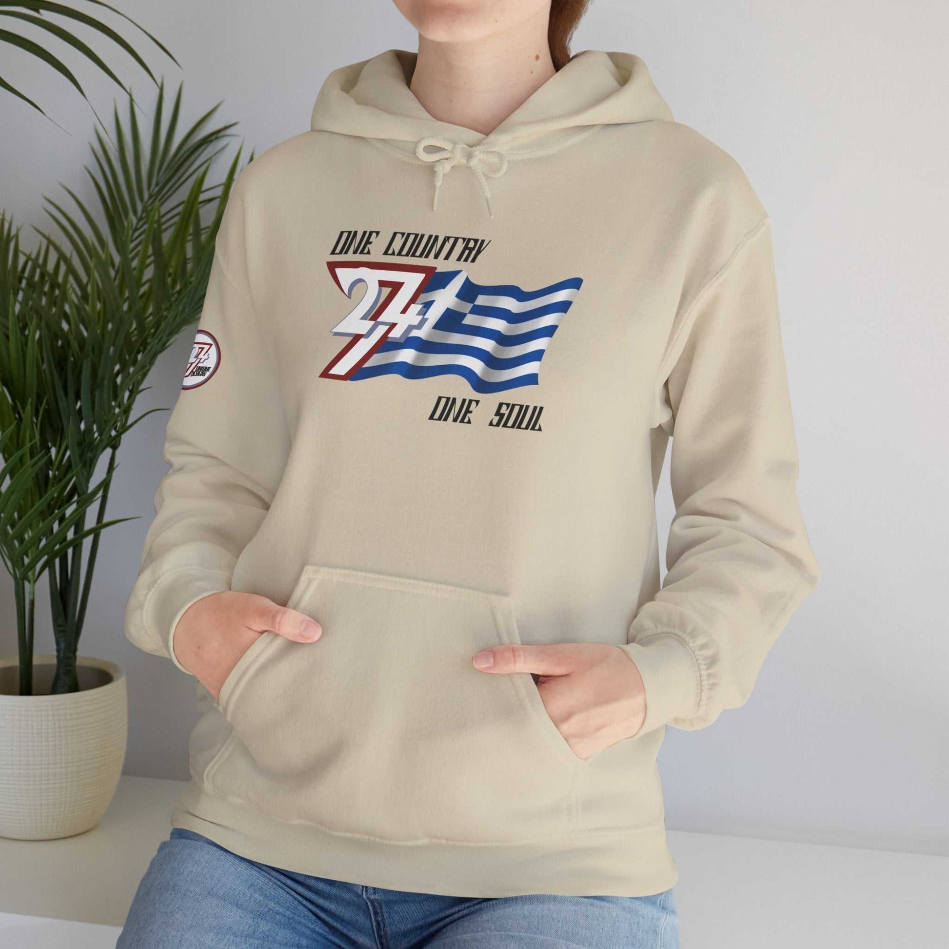 Male model styled in a Beige Hellas "Epic" hoodie, representing a modern, global streetwear aesthetic.
