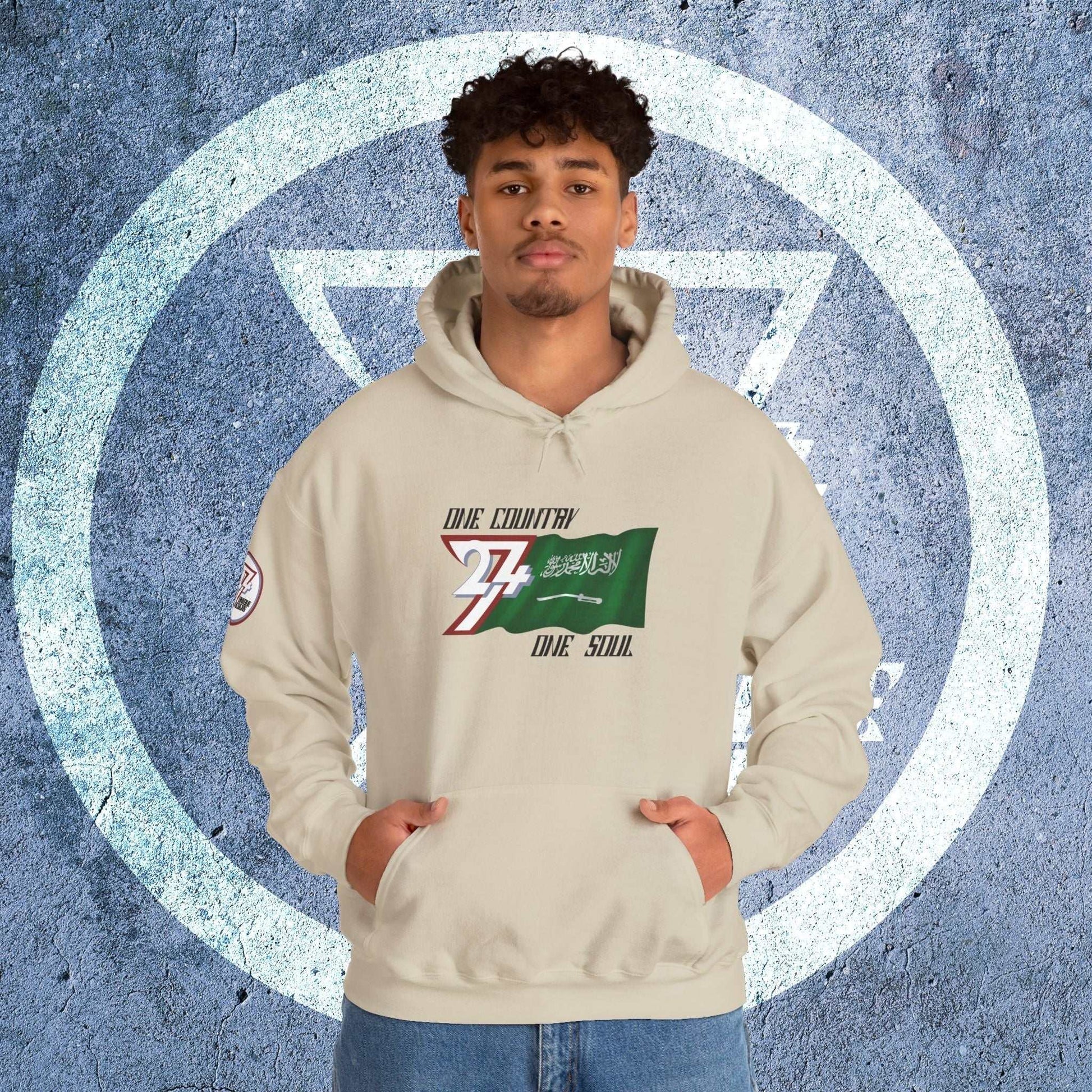 Male model wearing the Al-Mamlakah "Majesty" edition hoodie in Beige, showing a modern, refined Middle Eastern streetwear look.
