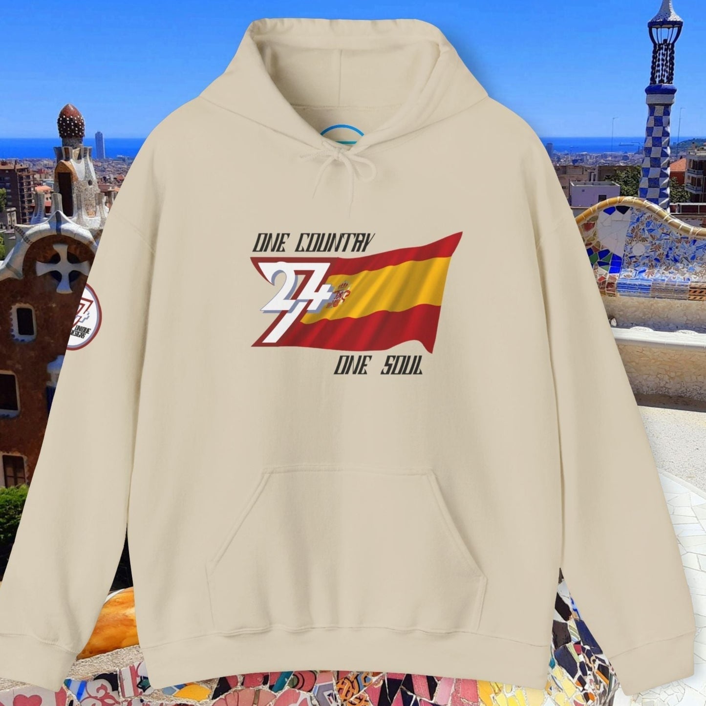 A polished Beige España flag hoodie with our signature hand-drawn art and "One Country One Soul" text.