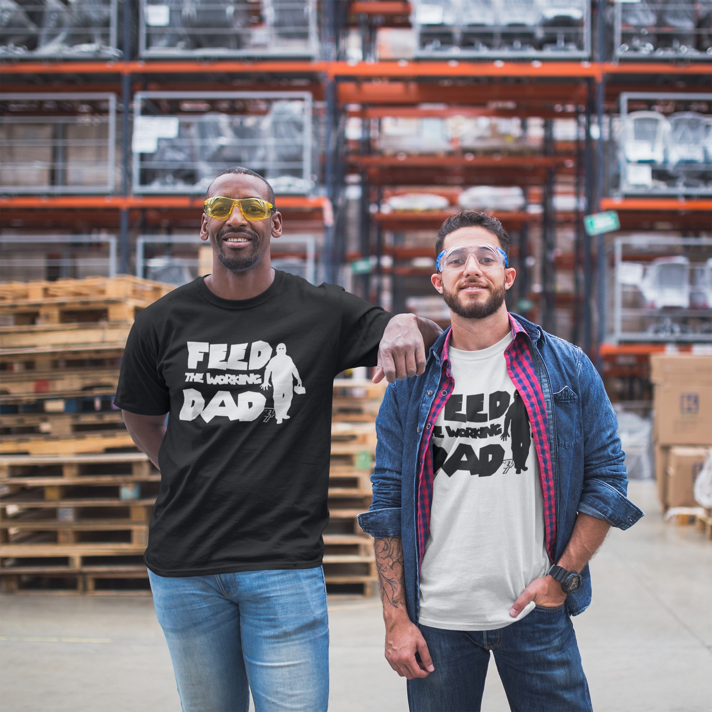 Two male models showcasing the black and white Feed the Working Dad t-shirts, highlighting the dynamic contrast printing in an industrial warehouse setting.