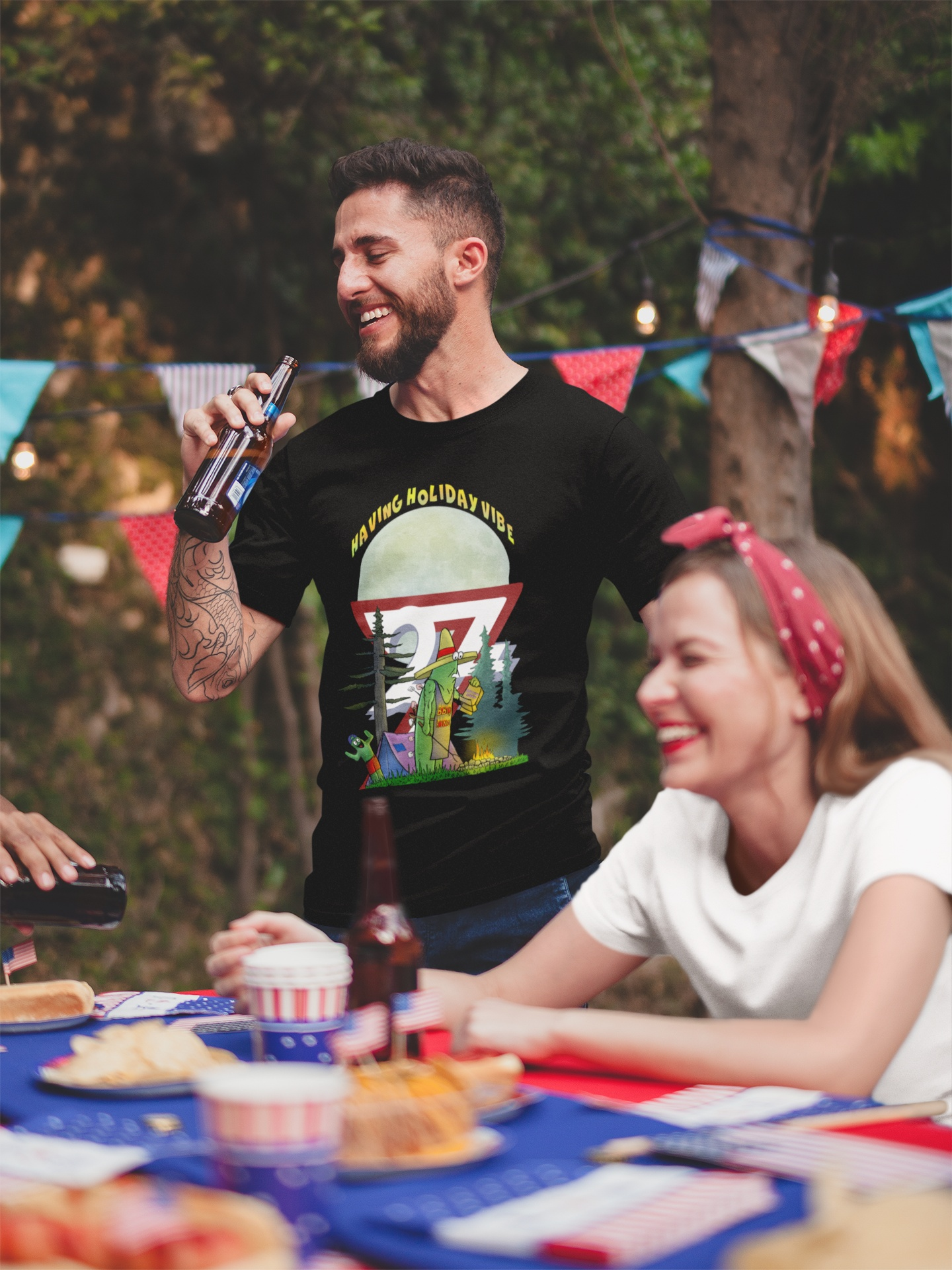 Man wearing a black novelty t-shirt featuring a humorous father-son cactus camping design with the words Having Holiday Vibe.