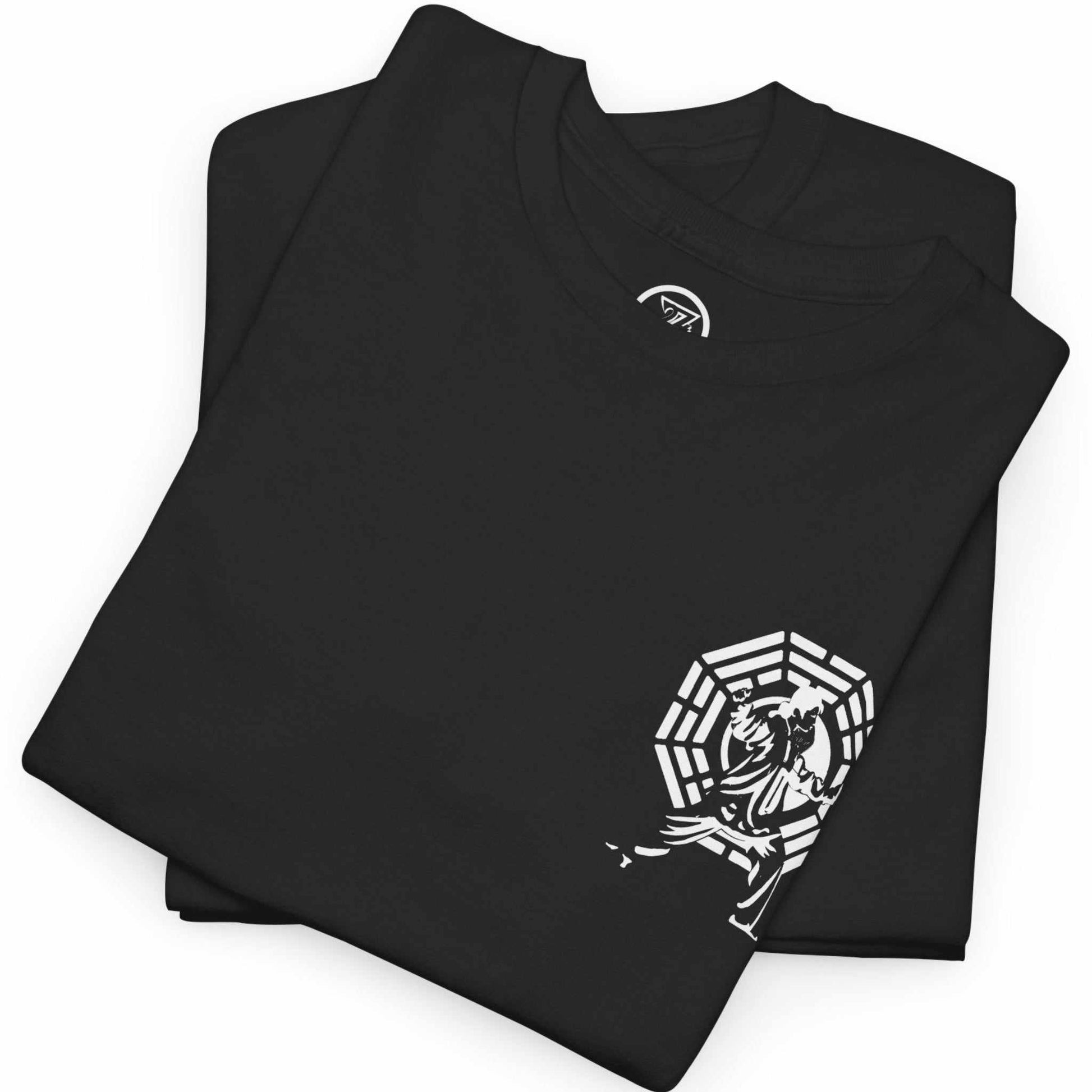 Neatly folded black Tai Chi t-shirt highlighting the crisp chest emblem and premium cotton fabric, laid flat.