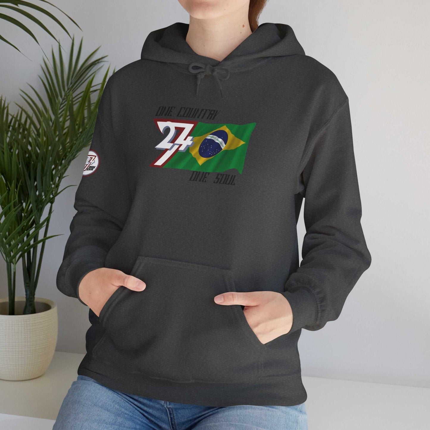 Female model wearing the Brazil "Soul" edition hoodie in Charcoal, showing a modern, refined streetwear look.
