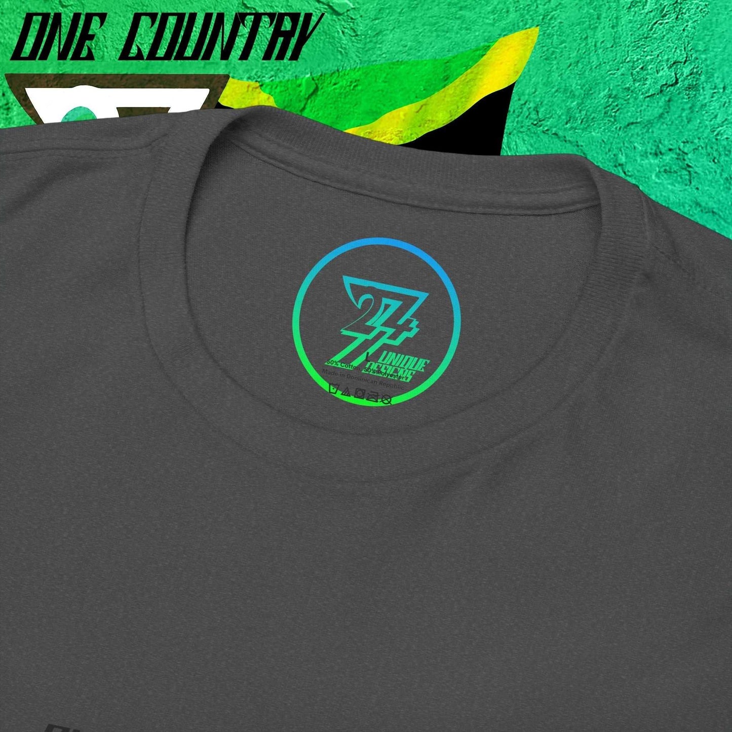 Close up collar view of the trade mark 24/7 Unique Designs logo on the dark grayunique Jamaica graphic tee