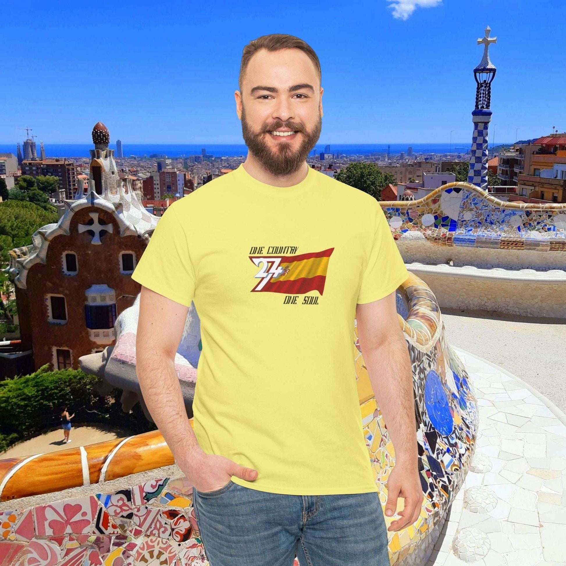 Man wearing yellow Spain flag graphic tee with hand-drawn España design in a Barcelona park setting