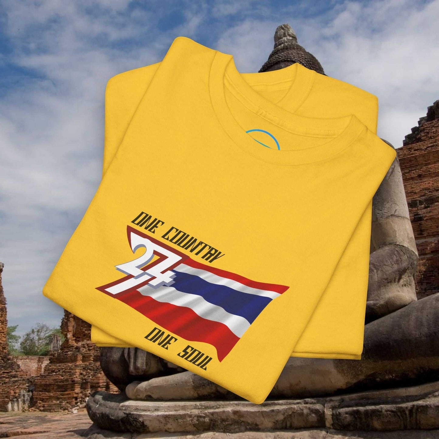 Daisy Thailand Flag T-Shirt with hand-drawn Thong Trairong graphic displayed on folded cotton tees against ancient temple background