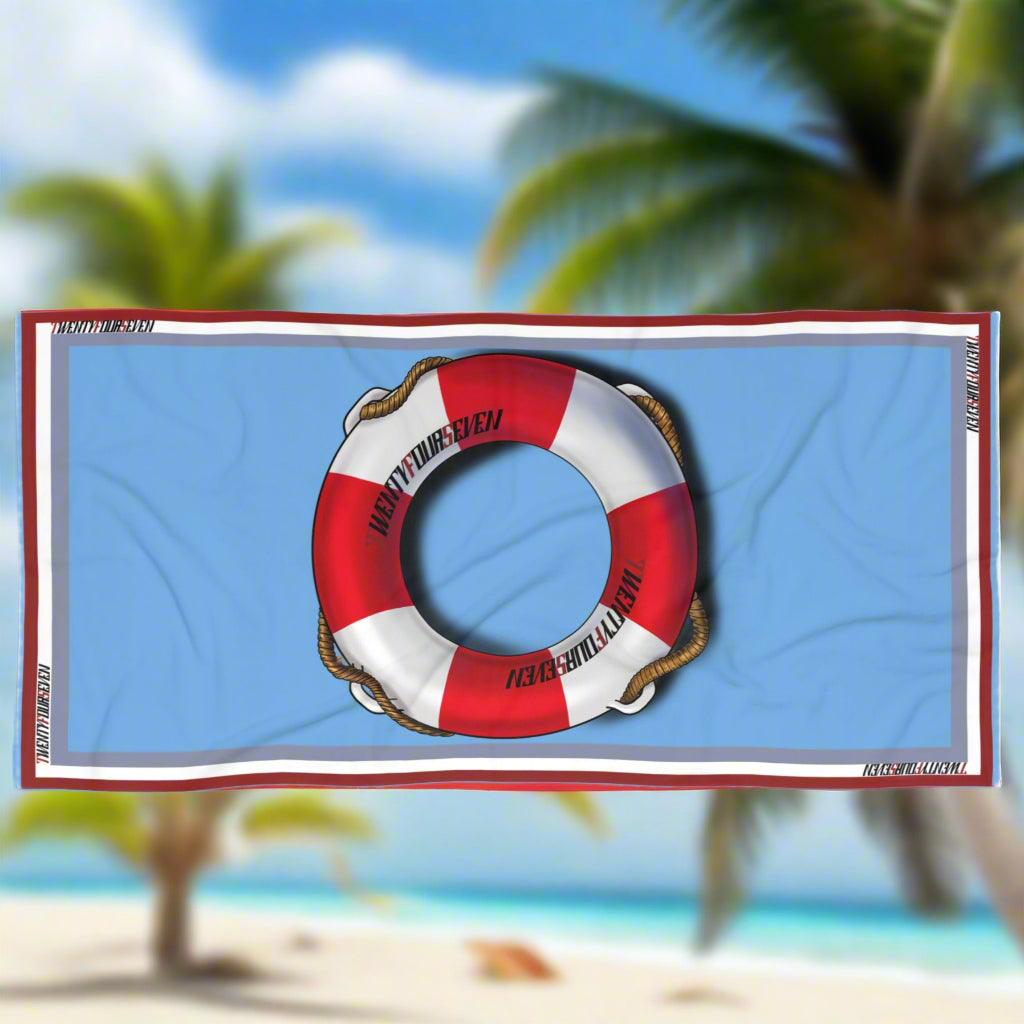Designer coastal towel featuring a classic life ring and 24/7 logo design.