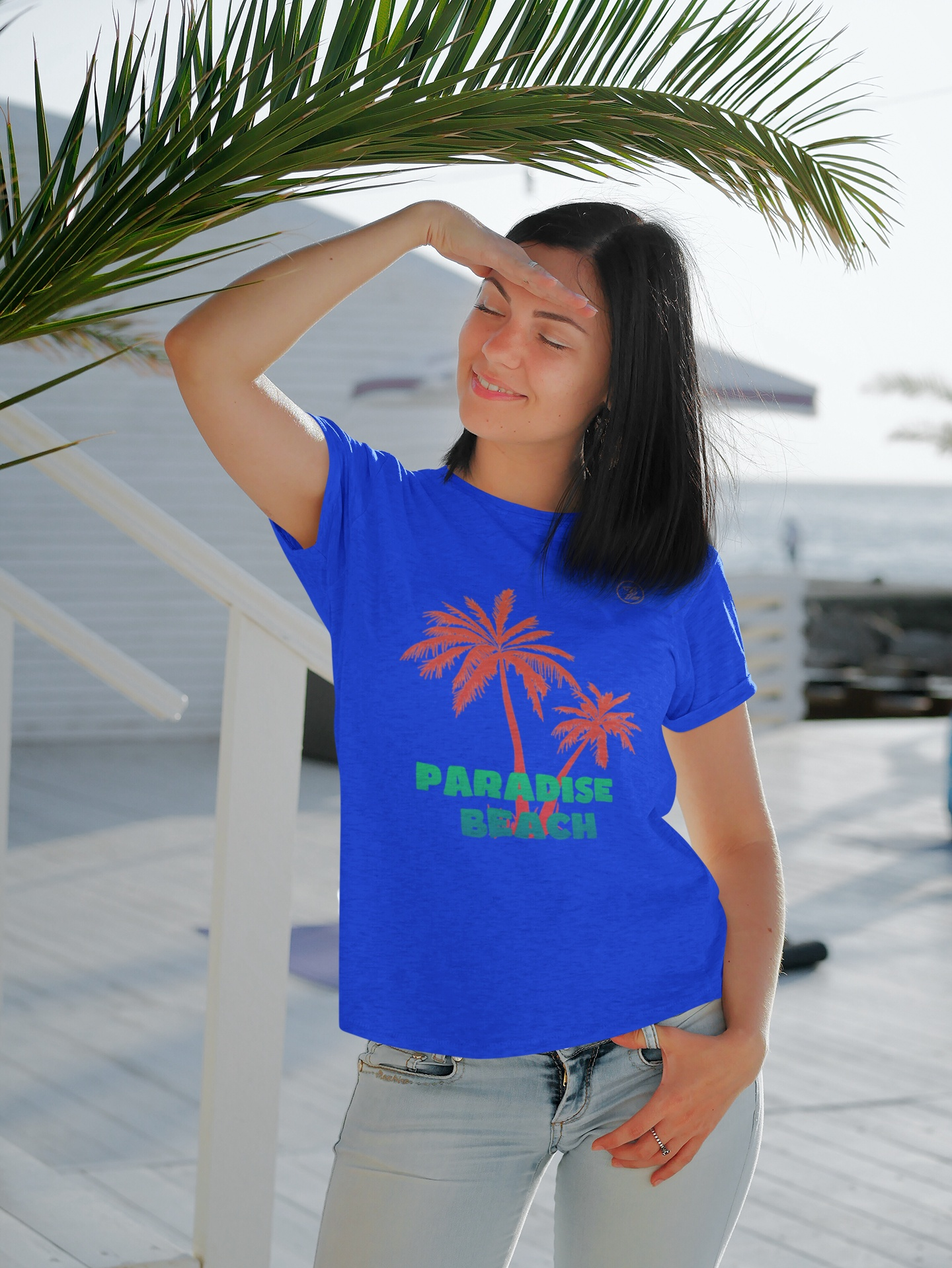Female model wearing the Royal Retro Palm Tree T-Shirt showcasing vintage palm tree art.