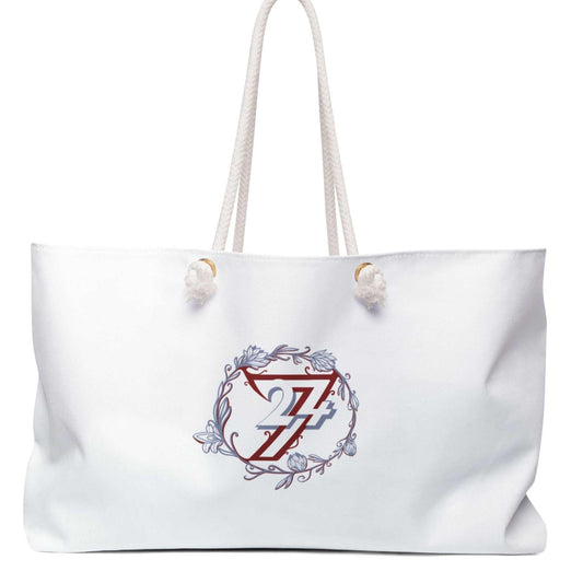 Front view of the white elegant floral weekender tote bag featuring the hand-drawn red and blue 24/7 floral wreath graphic, displayed on a clean white background.