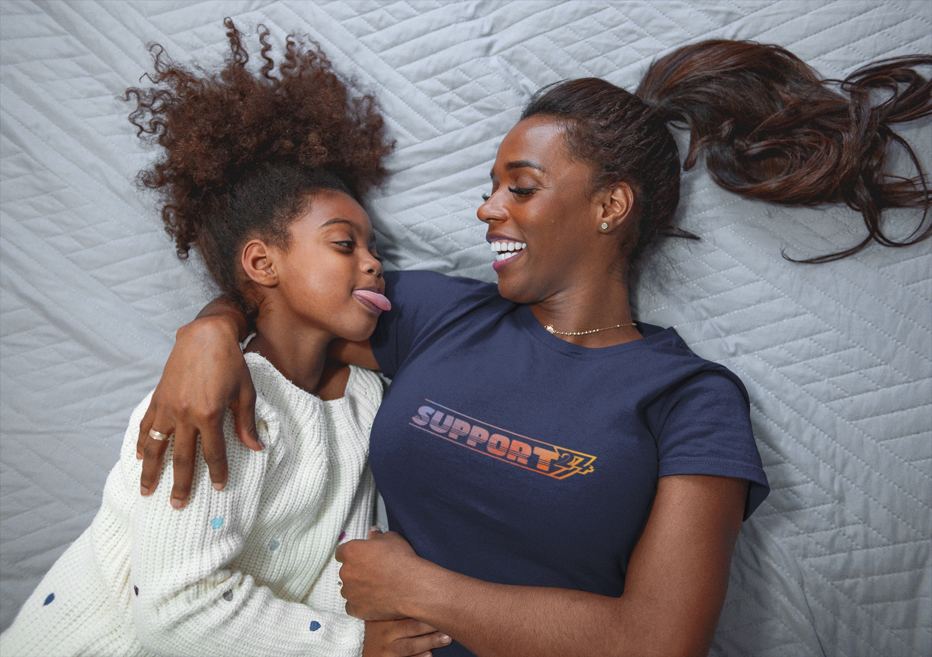 Female model demonstrating the classic unisex fit of the navy blue 24/7 Unique Designs family support shirt.