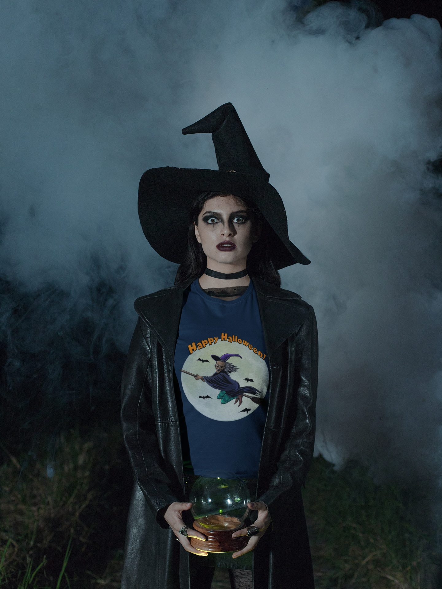 Front view of a female model styling the navy blue flying witch and full moon shirt.