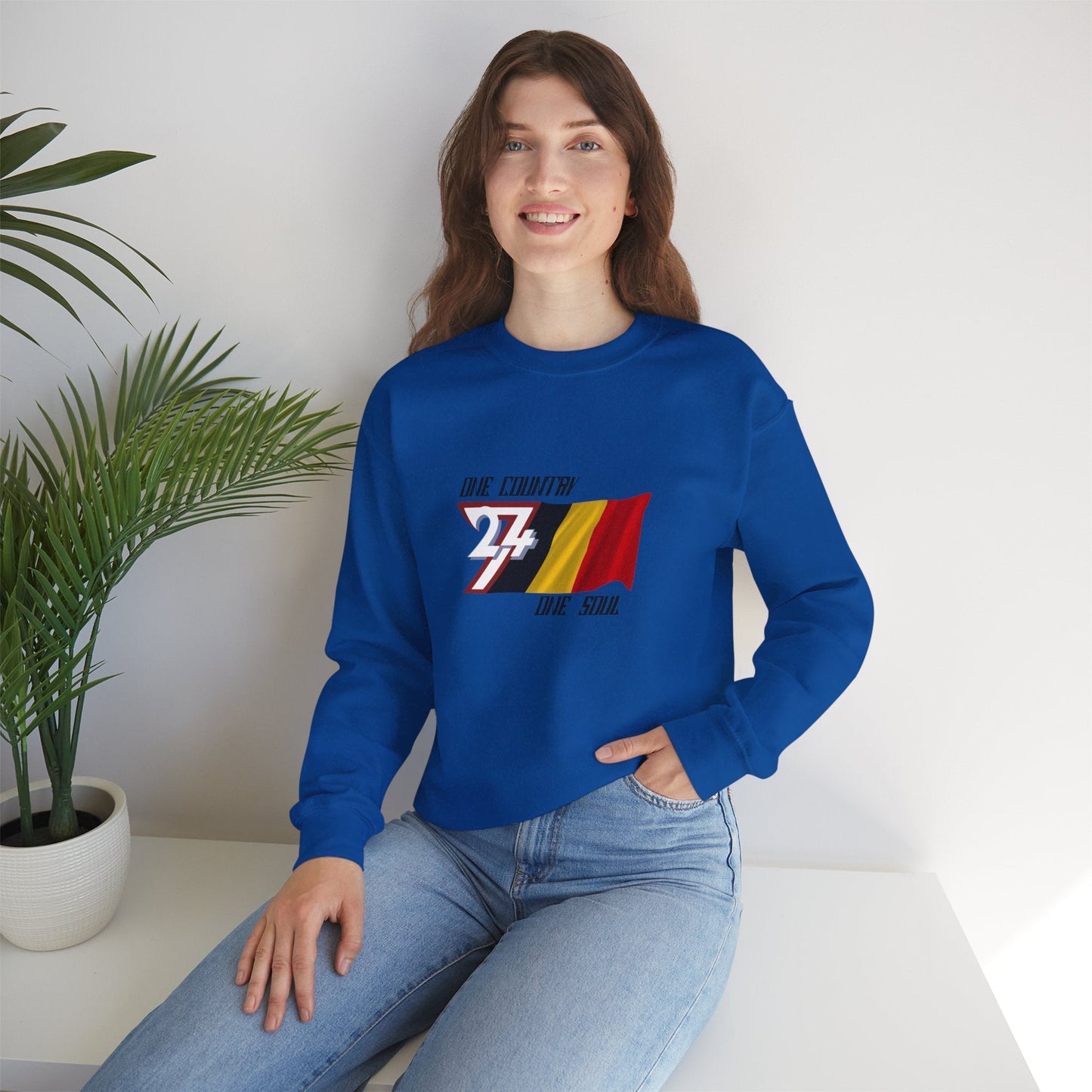 Front view of a female model wearing the royal blue Belgium flag graphic sweatshirt, demonstrating the classic fit.