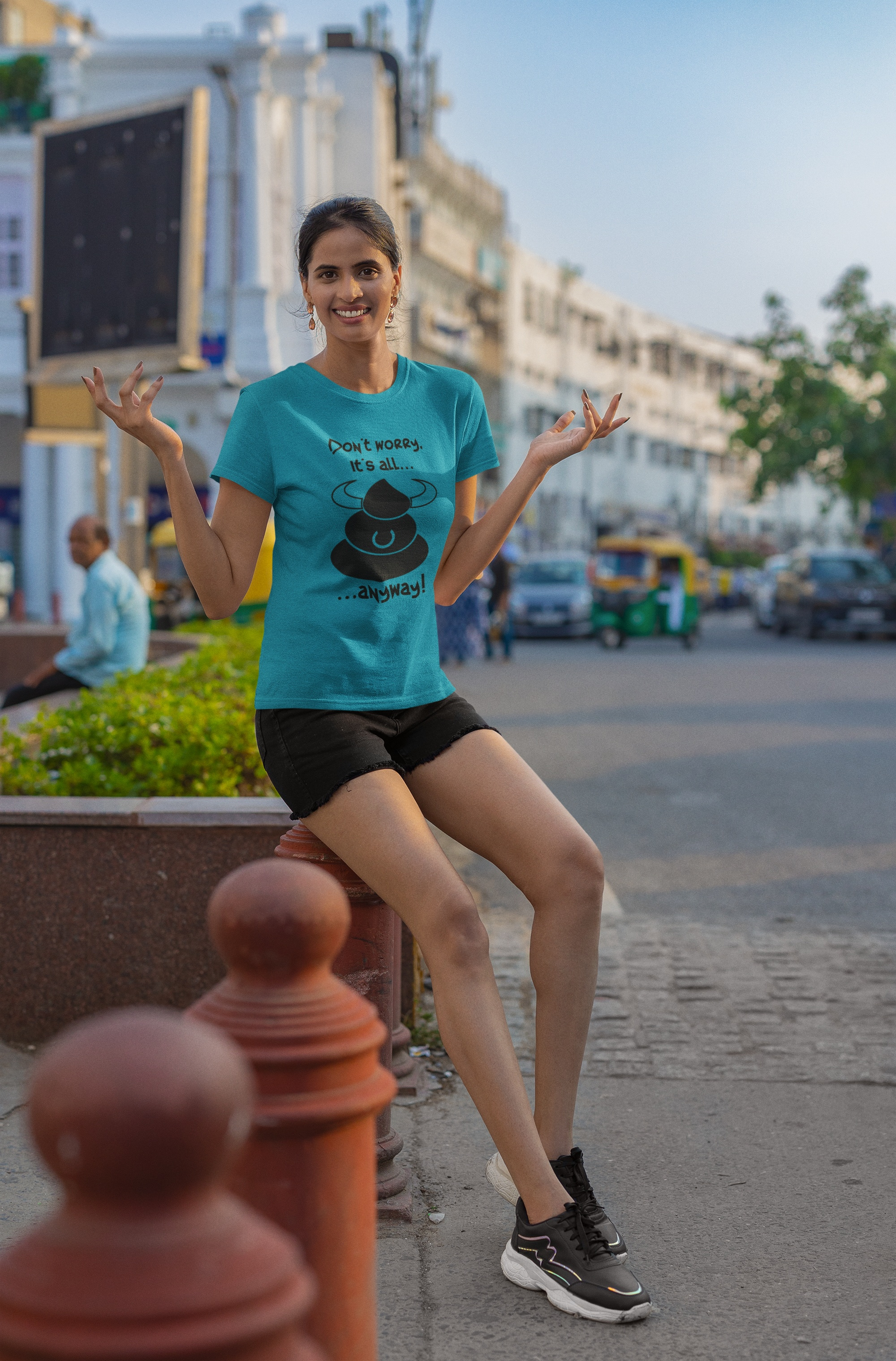 Female model showcasing the vibrant tropical blue stress relief tee, standing outdoors on a sunny, carefree day.