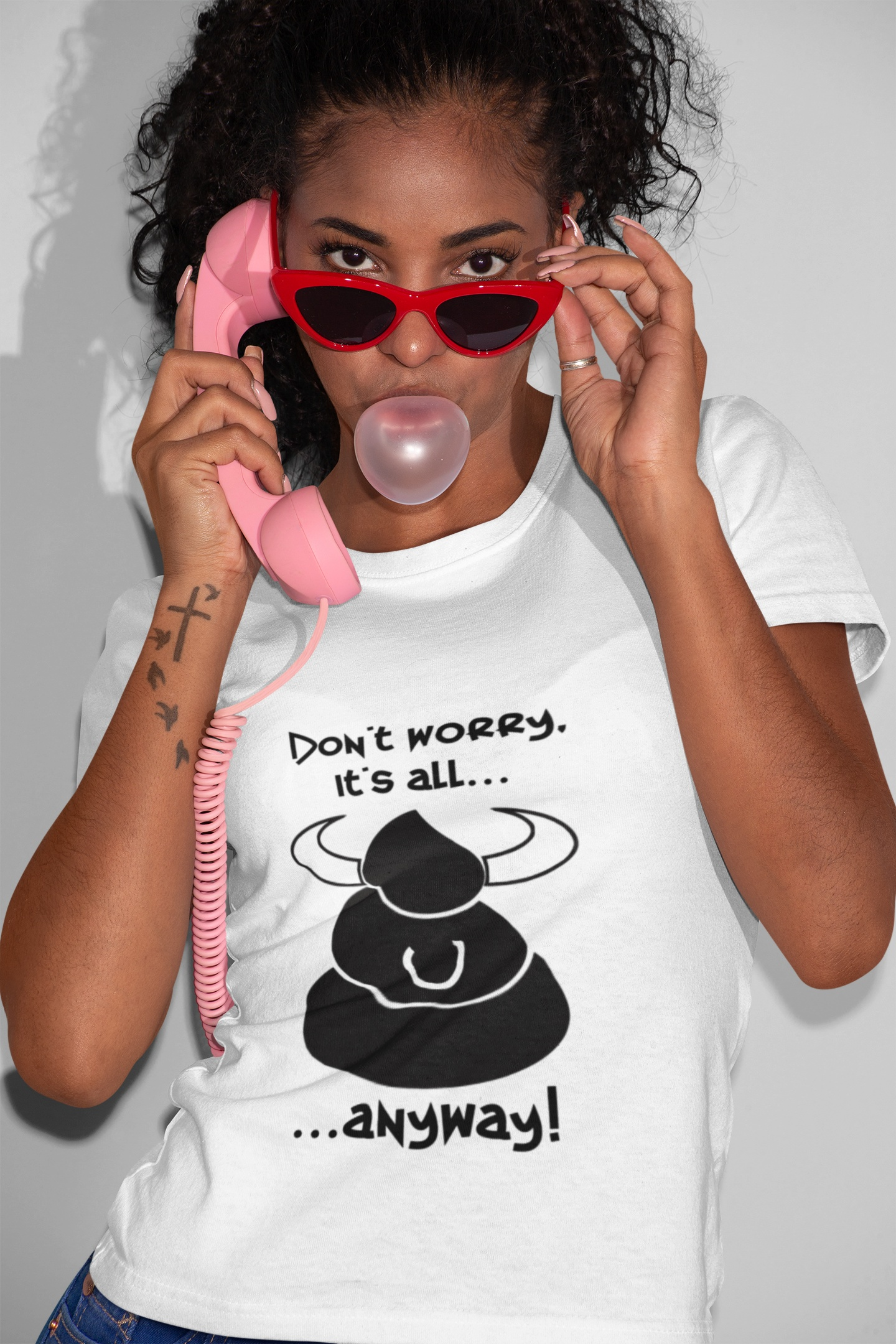 Female model wearing the white sarcastic don't worry shirt and blowing a bubble gum