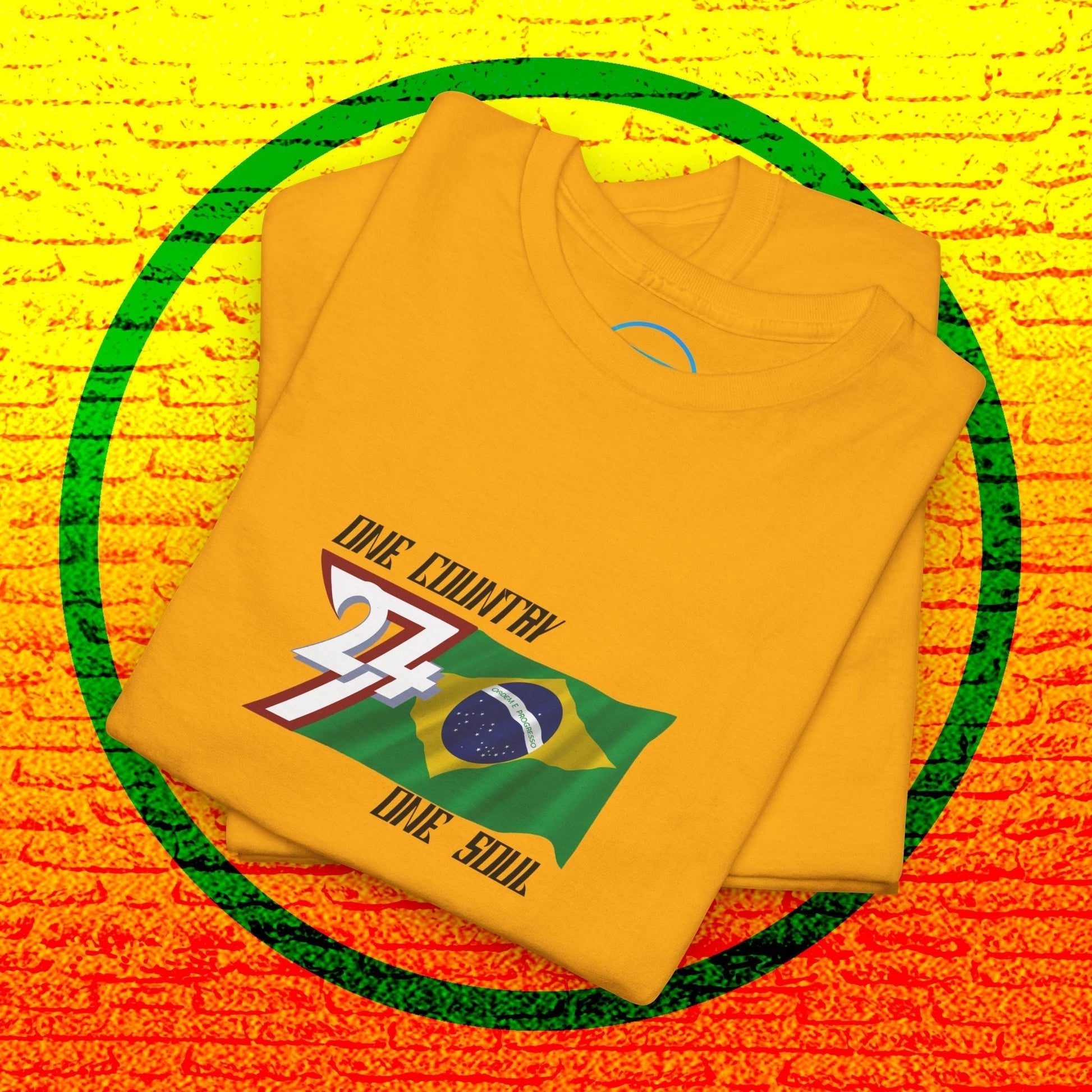 A professional display of the Brazil flag t-shirt in Gold, folded to showcase the refined hand-drawn graphic and high-quality fabric finish.