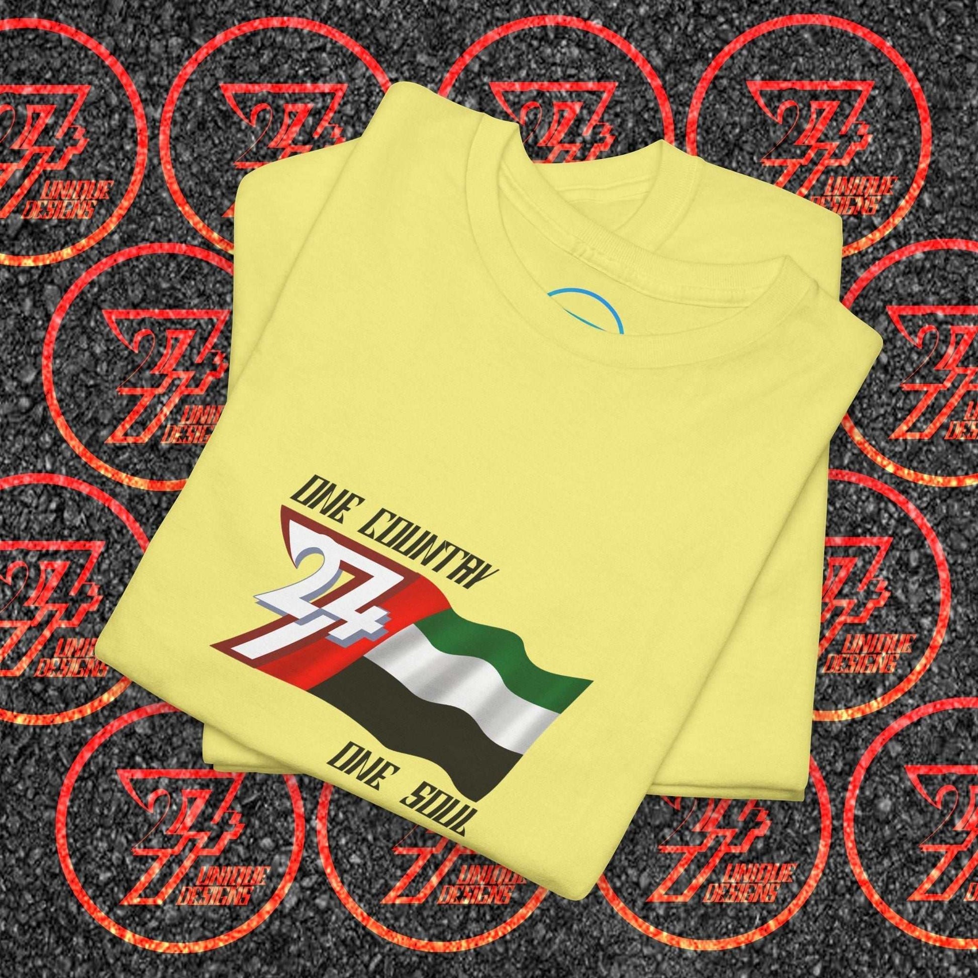 A professional display of the UAE flag t-shirt in Cornsilk, folded to showcase the refined hand-drawn graphic and high-quality fabric finish.