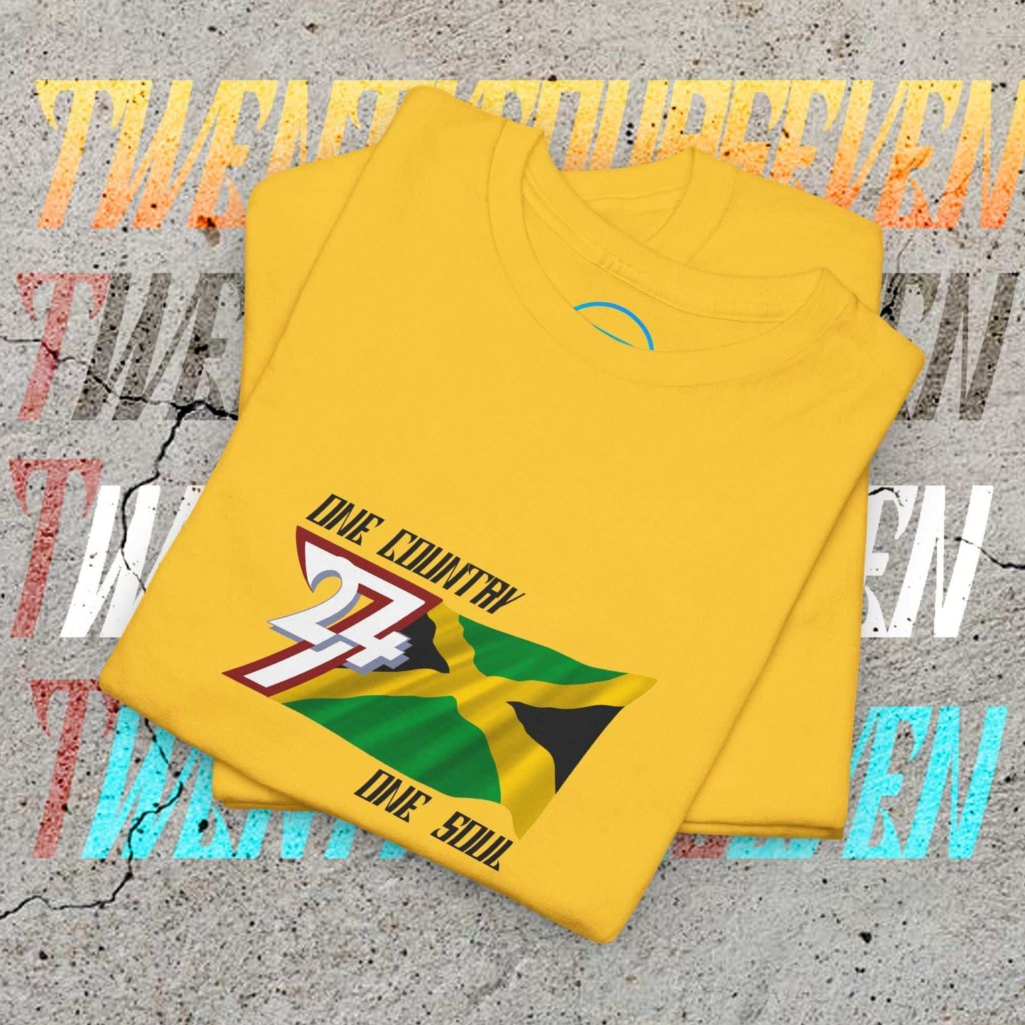 Neatly folded daisy cotton tee showing the hand-drawn Jamaican flag illustration and "One Country One Soul" text.