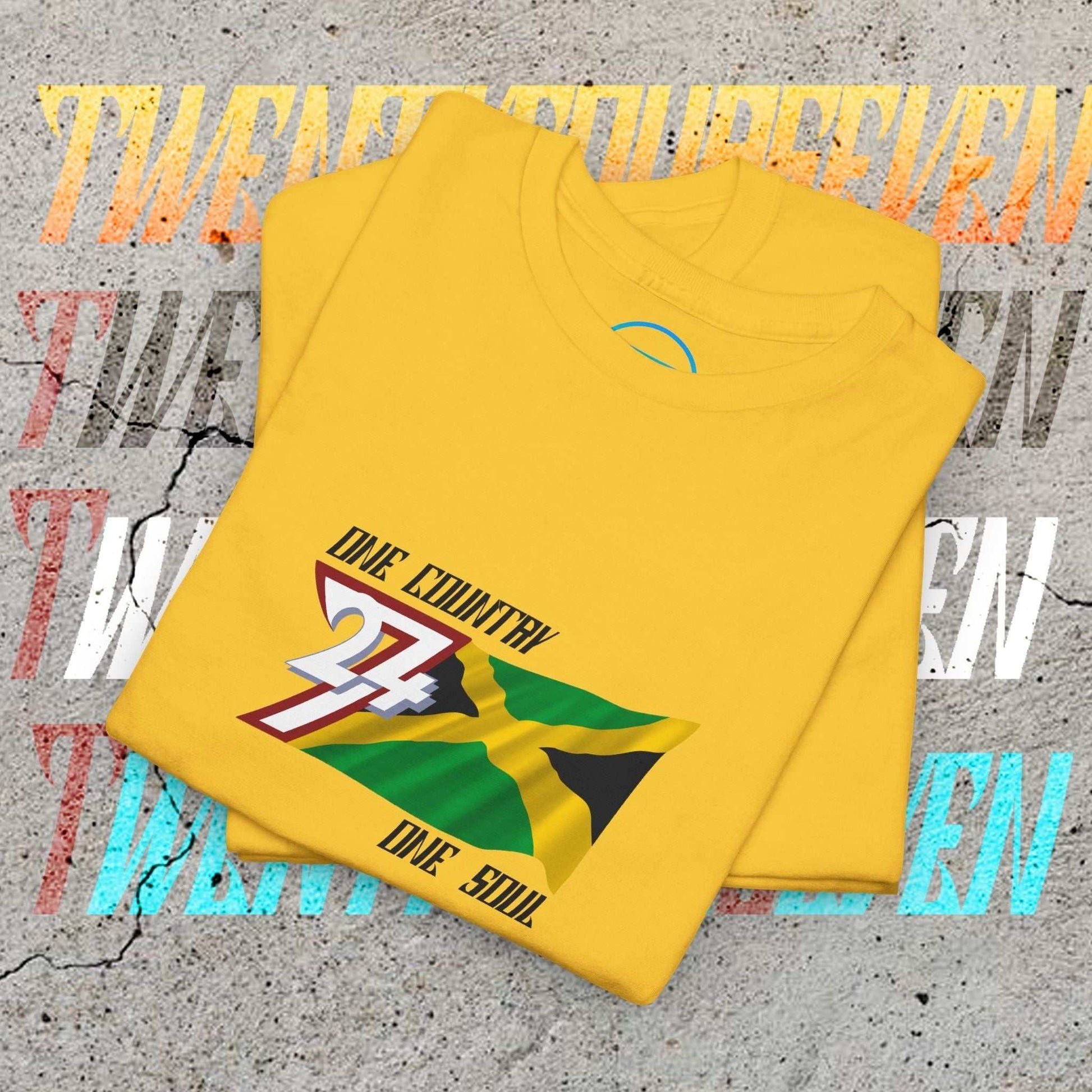 Neatly folded daisy cotton tee showing the hand-drawn Jamaican flag illustration and "One Country One Soul" text.