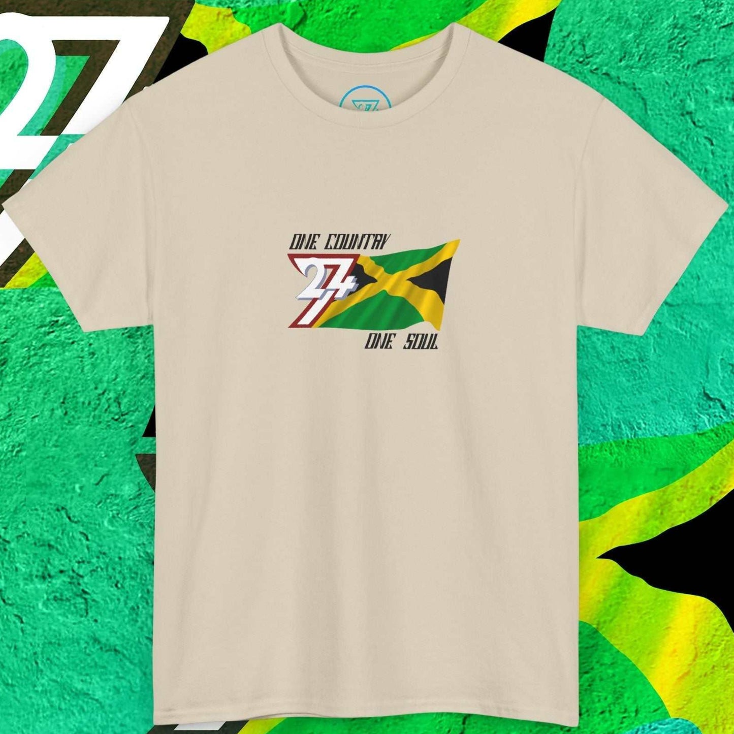 Hand-drawn Jamaican cross design on a beige t-shirt featuring the "One Country One Soul" branding.
