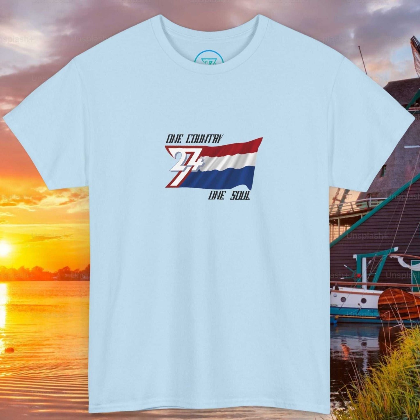 Front view of a light blue graphic t-shirt featuring a digitally hand-drawn Netherlands flag design.