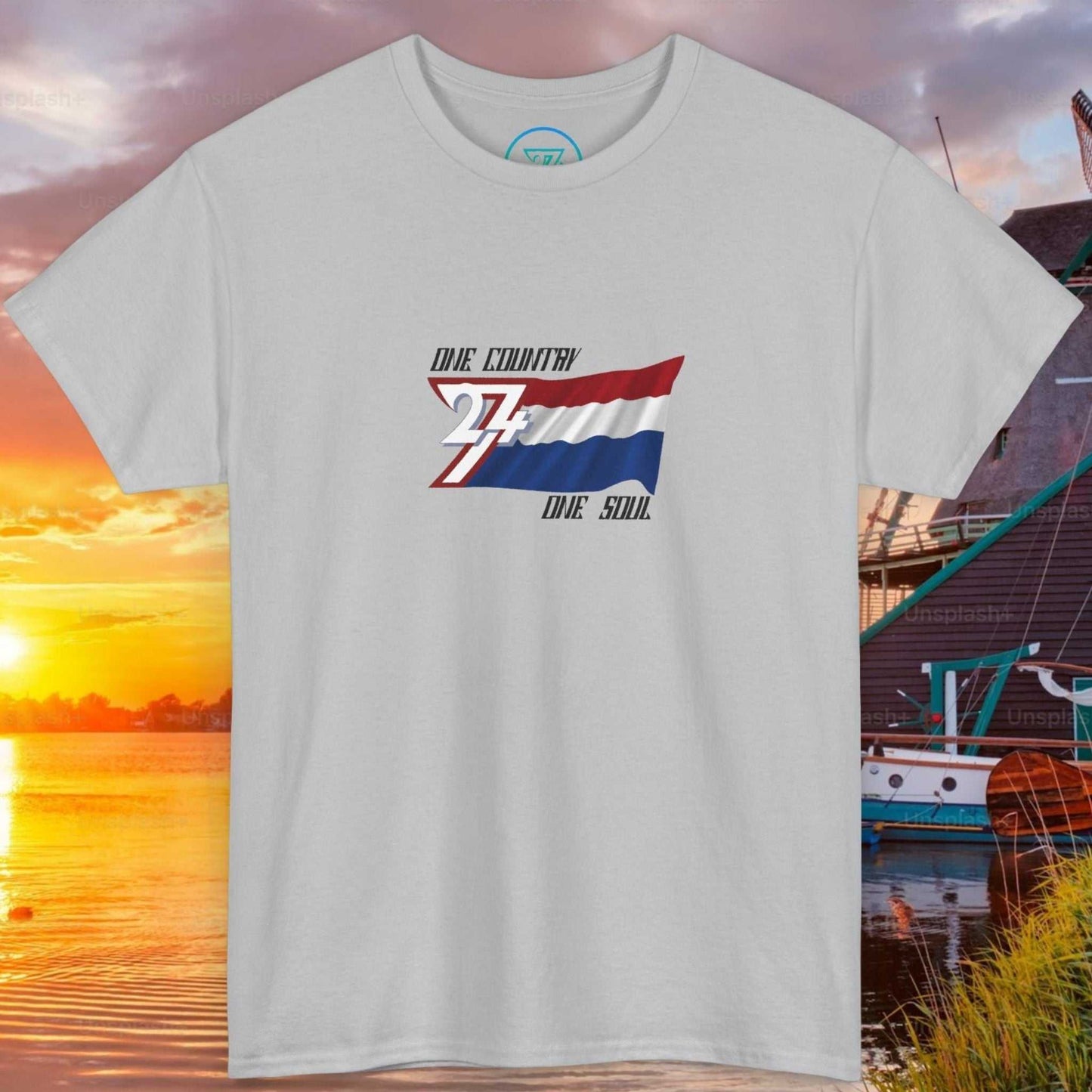 Front view of a light blue graphic t-shirt featuring a digitally hand-drawn Netherlands flag design.