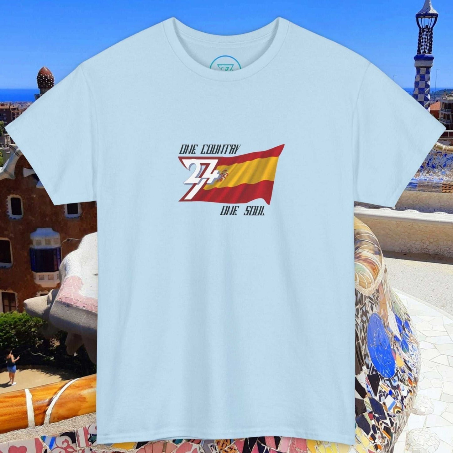 Light blue Spain Flag Graphic Tee with hand-drawn Spanish flag and "One country One soul" text, unisex fit.