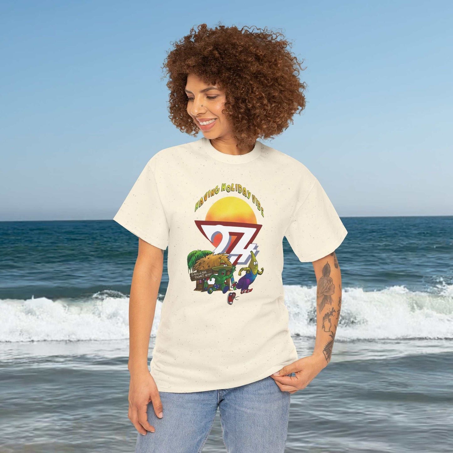 Female model styling the Natural color Graphic Tee with original 24/7 character art.