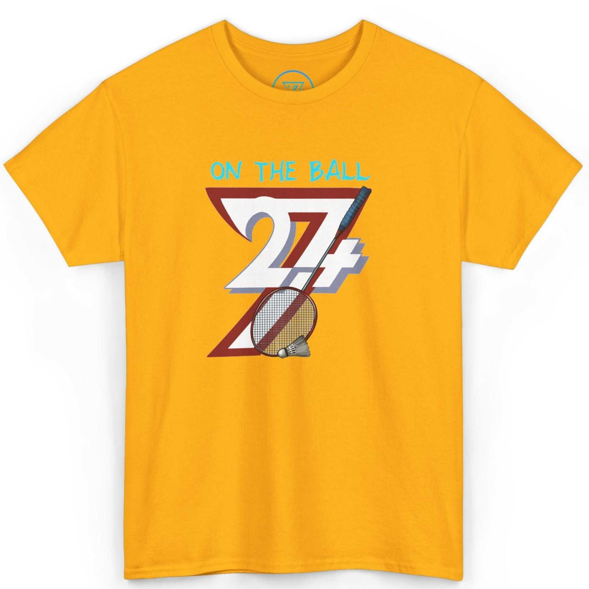 Front view of a vibrant gold comic-style badminton shirt highlighting the bold 24/7 logo and shuttlecock art, displayed on a clean background.