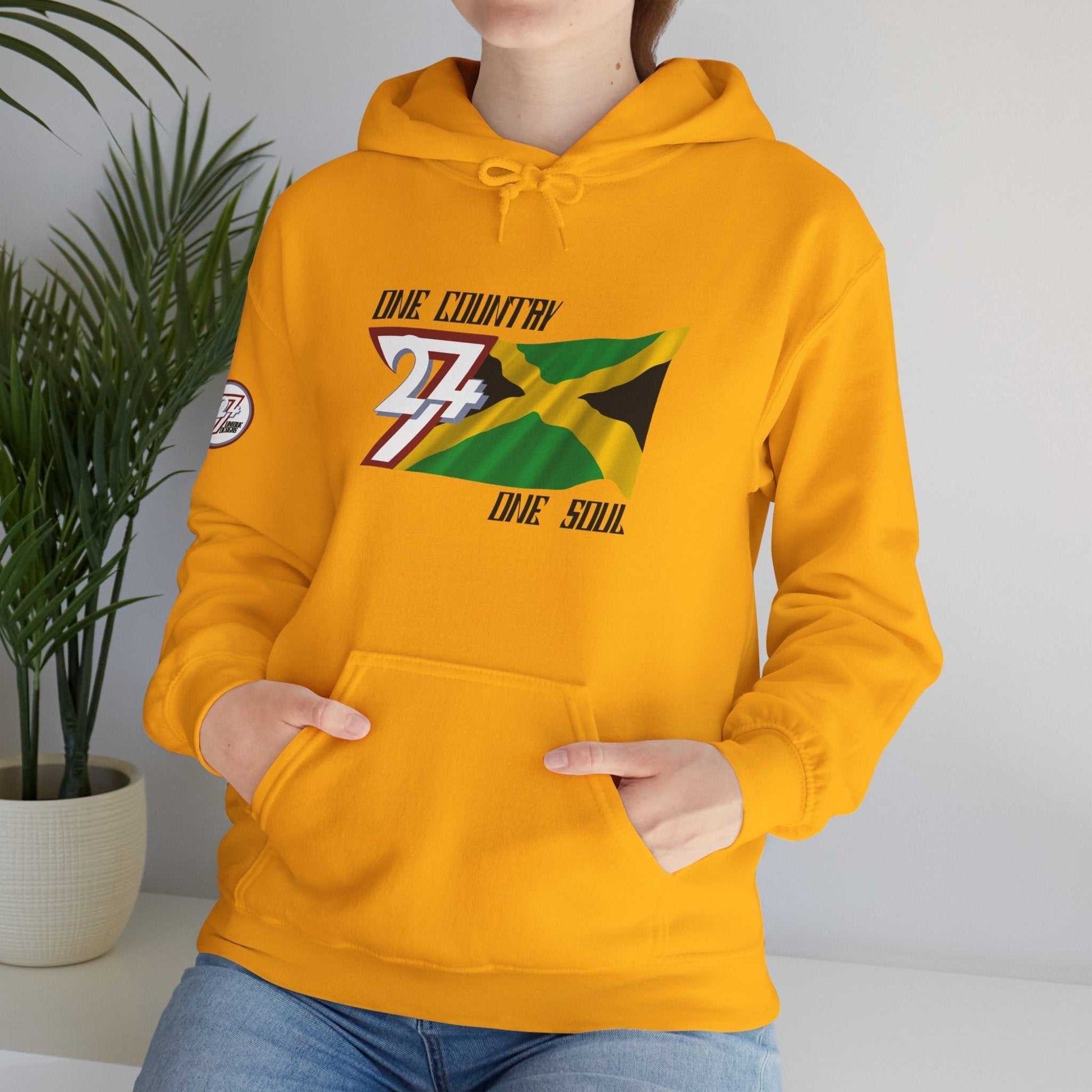 Female model wearing the Jamaica "Everlasting" edition hoodie in Gold, showing a modern, refined Caribbean streetwear look.