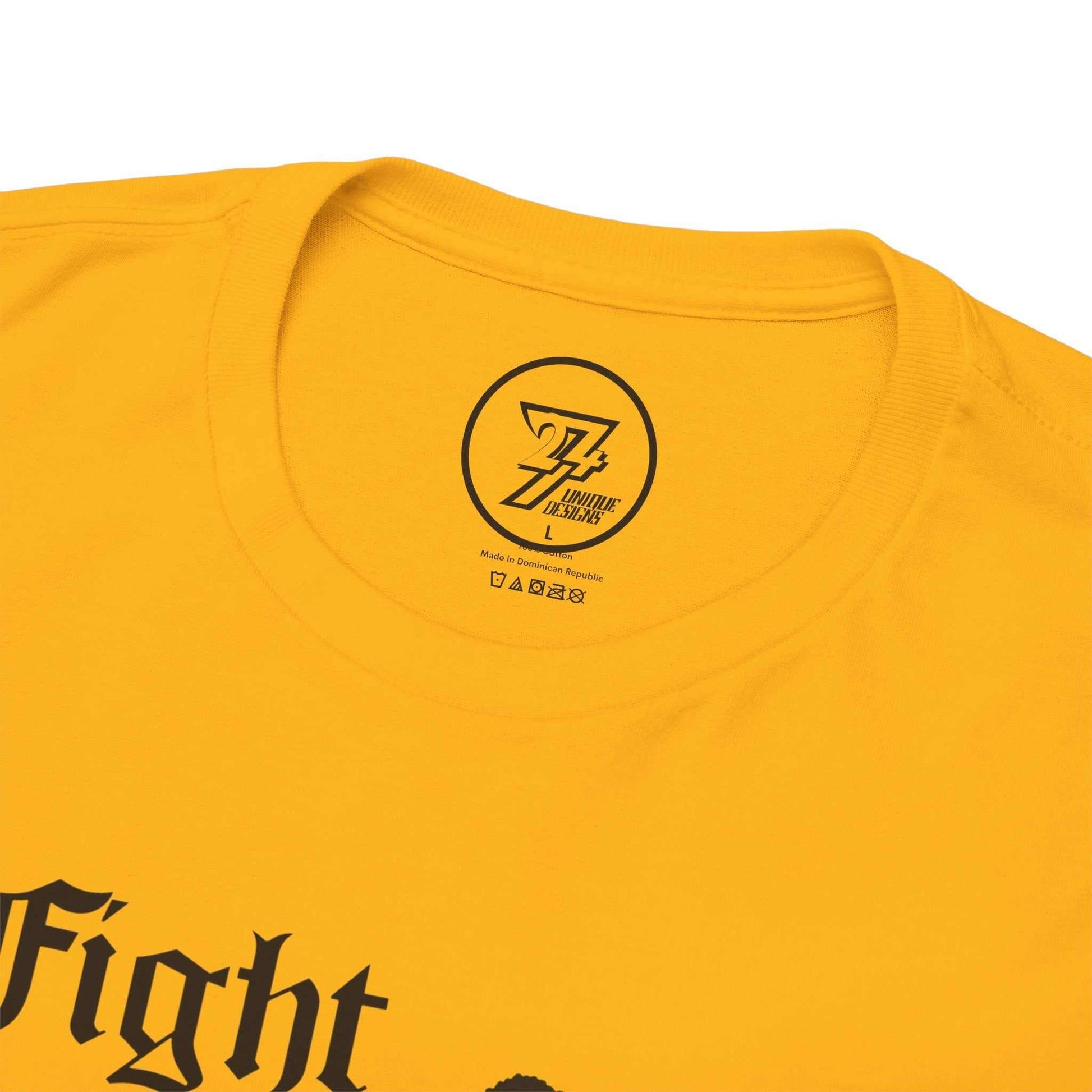 Close-up of the seamless crew neckline on the gold martial arts tee, clearly showing the official 24/7 Unique Designs inner label branding.
