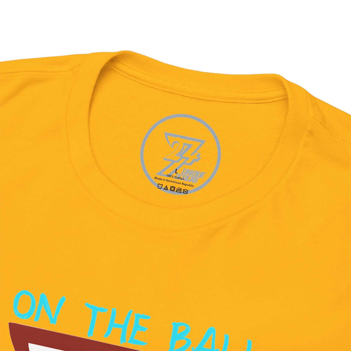 Close-up of the ribbed knit collar on the gold tailgate apparel tee, clearly showing the official 24/7 Unique Designs trademark logo inner label branding.