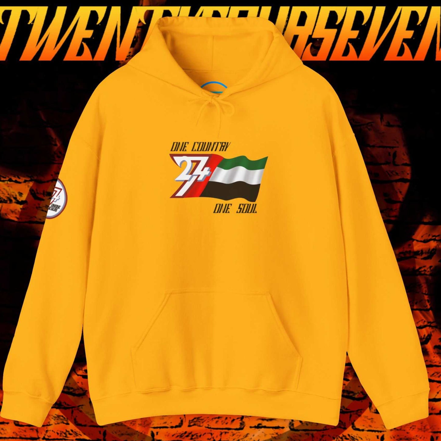 Front view of the Gold UAE flag hoodie featuring the refined artist-drawn design and motto.