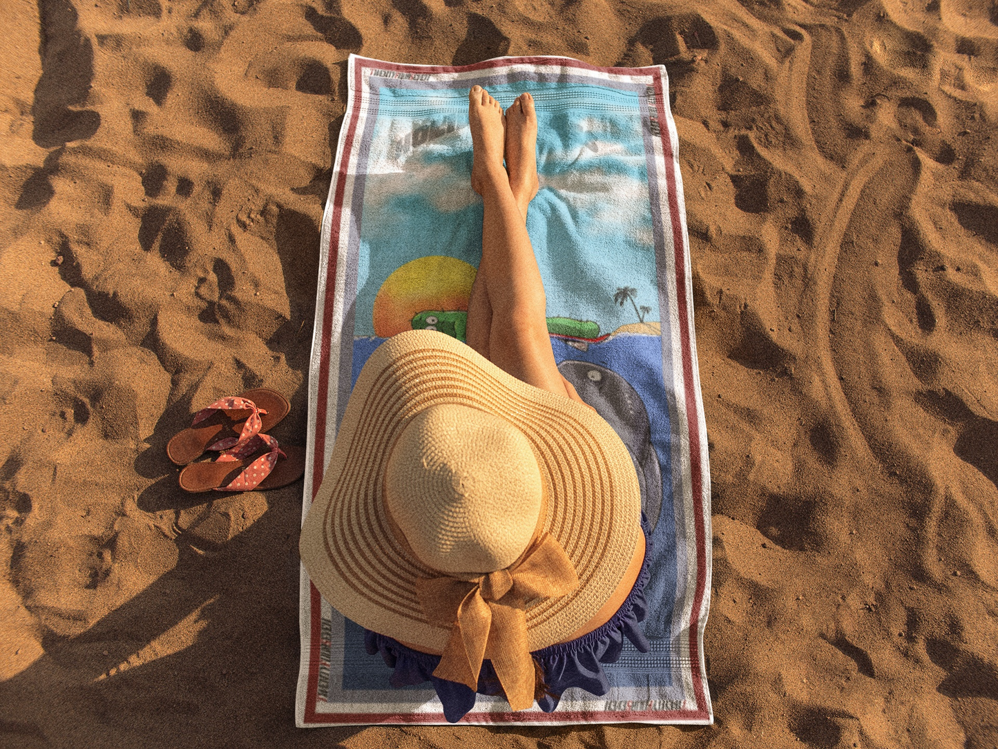 Graphic pool towel showing a severed cactus arm and a stunned yellow fish in vibrant blue water.