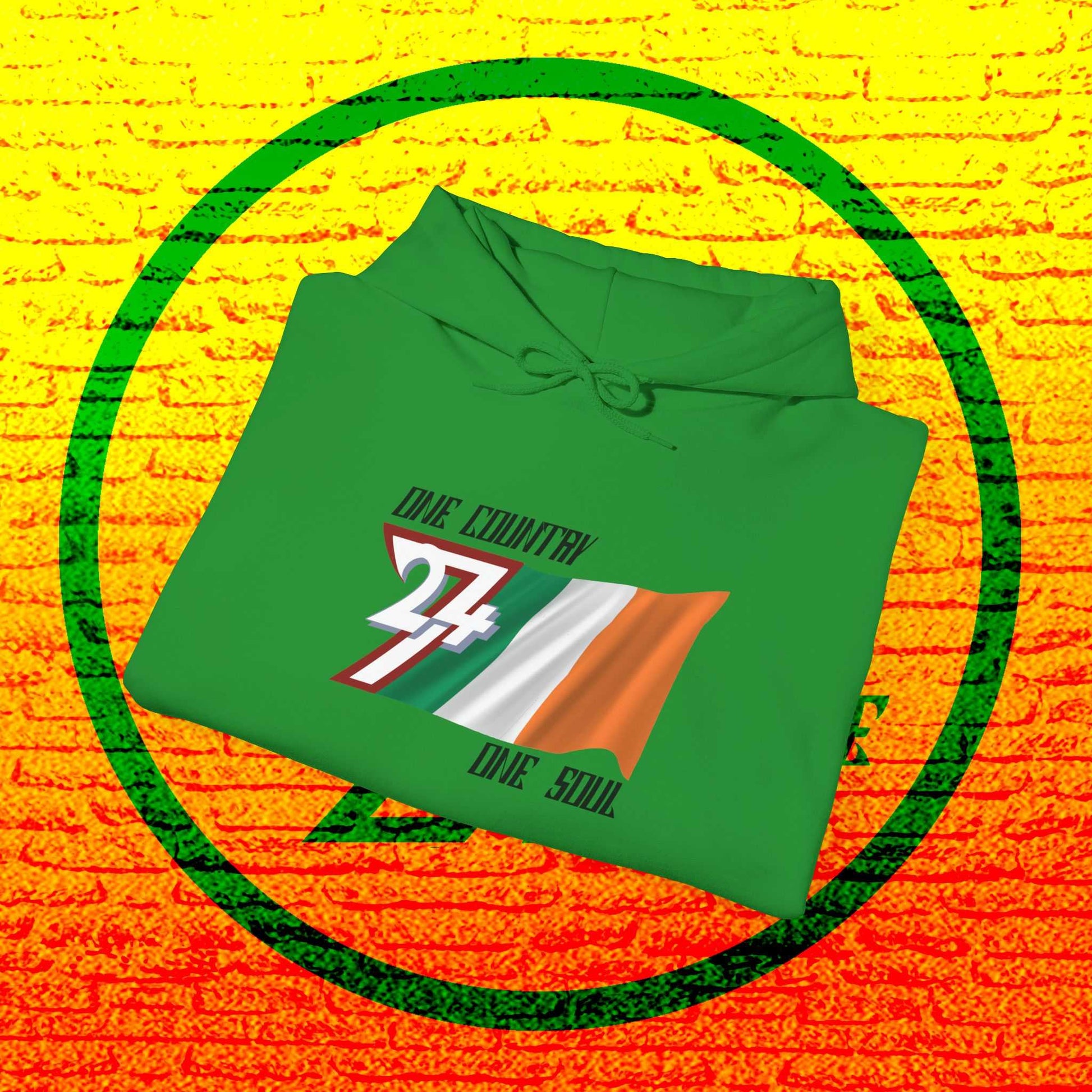 A professional display of the Éire flag hoodie in Irish Green, folded to showcase the refined hand-drawn graphic and 8oz fabric weight.