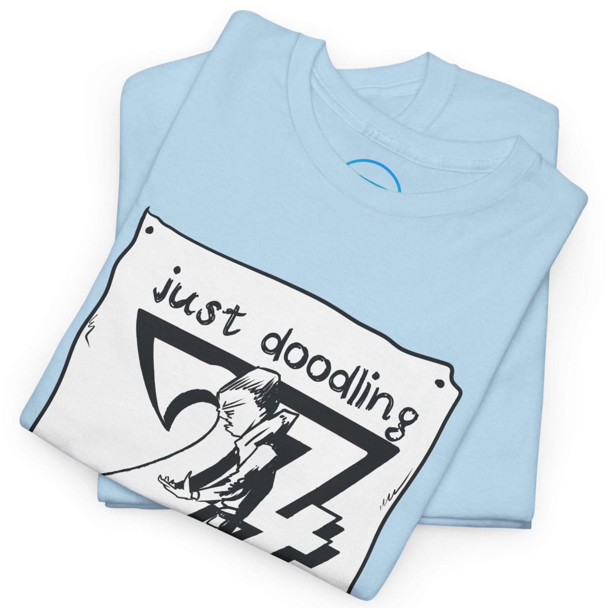 Neatly folded light blue hand-drawn dog caricature shirt showing the premium ethical cotton fabric and the crisp sketch print, laid flat.